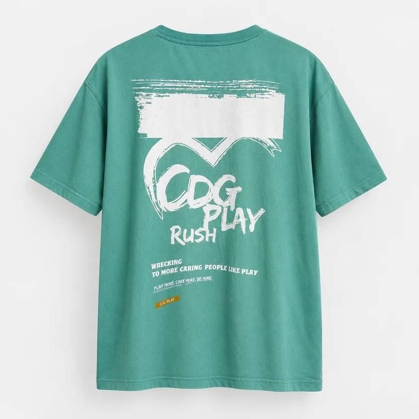 Comme des Garçons PLAY (Category: Luxury Apparel) located in Caloocan City. Submitted by tlgroove (Listing ID 1467215100, Image 1). Description: Excellent condition (No issue) Color rate: 9.7/10 Dimes: 24 x 30 Best fit: XL-XXL Graphic & Design Features • Brand Inscriptions: The back of the t-shirt features a large, stylized hand-drawn "CDG PLAY RUSH" text layout in white block lettering. • Graphic Text Elements: Below the main insignia, there is 