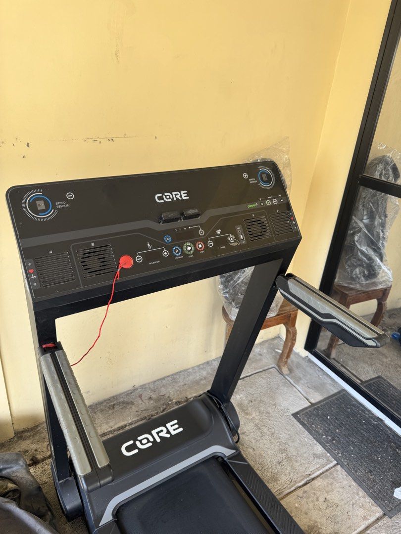CORE iWalk Treadmill (Category: Cardio & Fitness Machines) located in Bacoor. Submitted by iampaulineeee (Listing ID 1468585226, Image 3). Description: - Brand/Model: CORE iWalk Treadmill - Color: Black and Grey - Features: Digital display (speed, inclination, programs), built-in speakers, and heart-rate grip sensors - Safety: Includes safety stop key with red cord - Design: Foldable space-saving design for easy upright storage - Condition: Norma