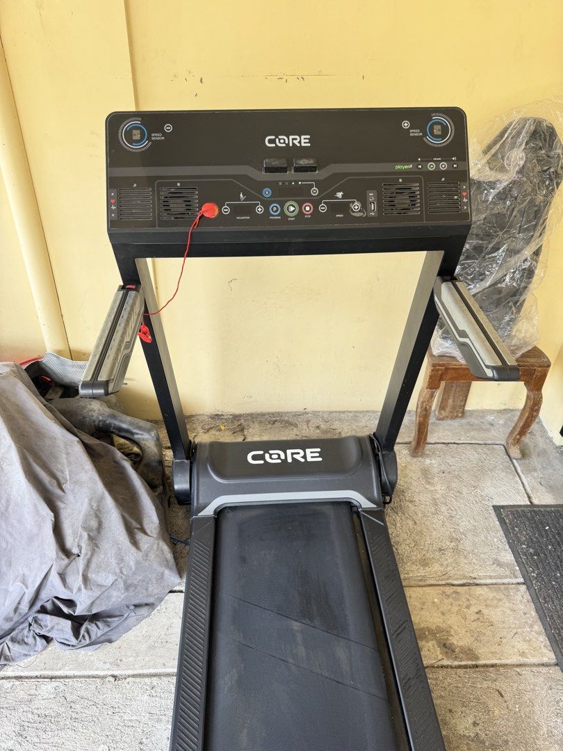 CORE iWalk Treadmill (Category: Cardio & Fitness Machines) located in Bacoor. Submitted by iampaulineeee (Listing ID 1468585226, Image 2). Description: - Brand/Model: CORE iWalk Treadmill - Color: Black and Grey - Features: Digital display (speed, inclination, programs), built-in speakers, and heart-rate grip sensors - Safety: Includes safety stop key with red cord - Design: Foldable space-saving design for easy upright storage - Condition: Norma