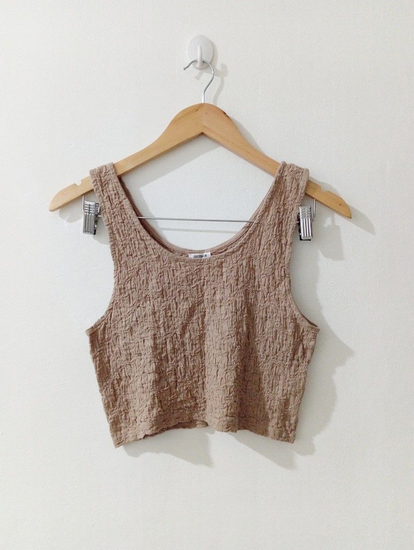 Cotton On Brown Textured Crop Top (Category: Sleeveless) located in Manila. Submitted by cococlo_ (Listing ID 1468658667, Image 1). Description: - Brand: Cotton On - Color: Brown - Material: Stretchy textured crinkle fabric - Design: Wide straps and scoop neckline - Fit: Comfortable and easy to wear - Styling: Perfect basic piece to pair with high-waisted jeans or skirts - Condition: Clean and well kept.