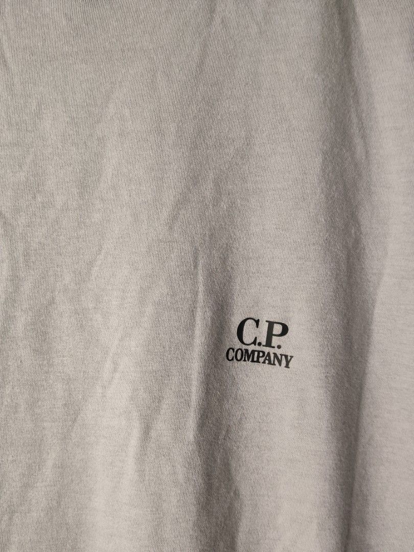 C.P. Company Grey T-Shirt (Category: Tshirts & Polo Shirts ) located in Quezon City. Submitted by needforthrift (Listing ID 1468625905, Image 3). Description: - Authentic grey C.P. Company t-shirt - 100% comfortable cotton with crew neck style - Features small chest logo print - Complete with interior collar branding and authentic product QR code wash label dimes: 21 width 28 length issue : pin hole authentic - Message us for more details or fast