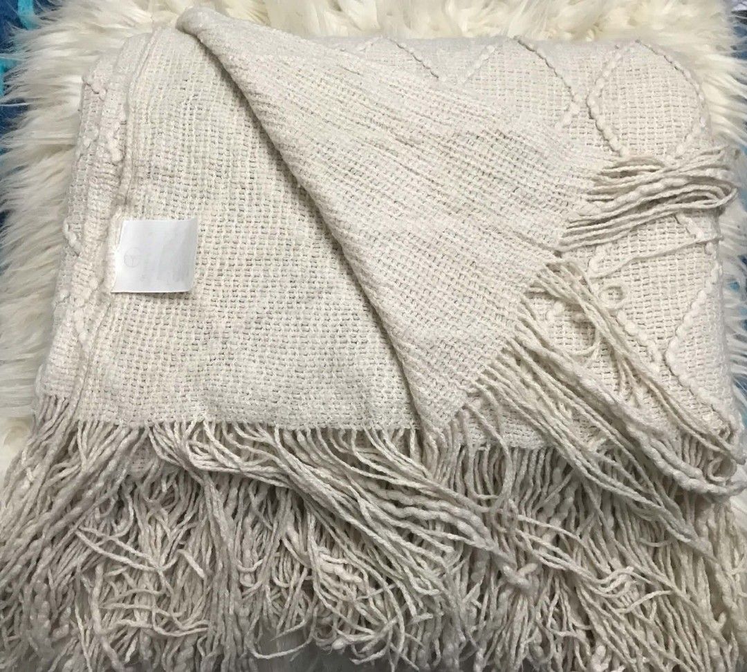 Cream Boho Knitted Throw Blanket with Fringe (Category: Other Home Decor) located in Imus. Submitted by stop_shop7 (Listing ID 1468553074, Image 2). Description: - Colour: Cream - Material: Soft textured knit - Design: Diamond tufted pattern with long fringe trim on both ends - Usage: Perfect for draping over a sofa or bed - Style: Neutral tone that matches most home decors -Need wash.