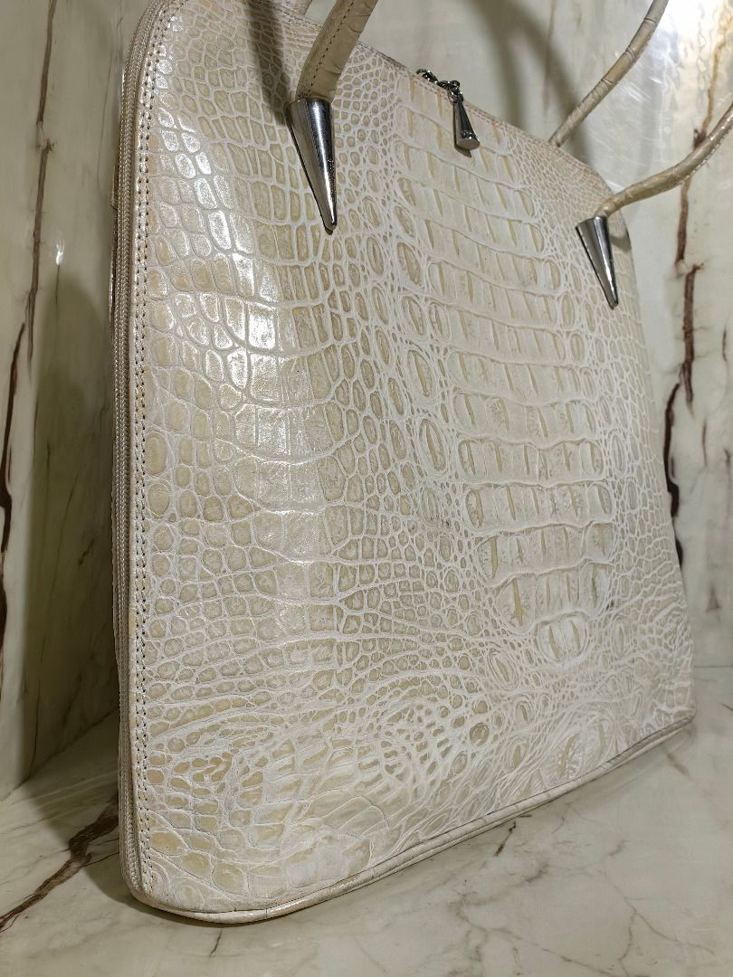 Cream Crocodile Leather Shoulder Bag (Category: Shoulder Bags) located in Tarlac. Submitted by jeremiah.curator.2026 (Listing ID 1468505569, Image 3). Description: - Color: Cream Crocodile Leather - Design: Structured shape with a flat bottom base - Straps: Dual shoulder straps featuring unique silver cone hardware accents - Closure: Secure top zip closure with cute tiny cone silver zipper pulls - Storage: Includes a convenient exterior back zipp
