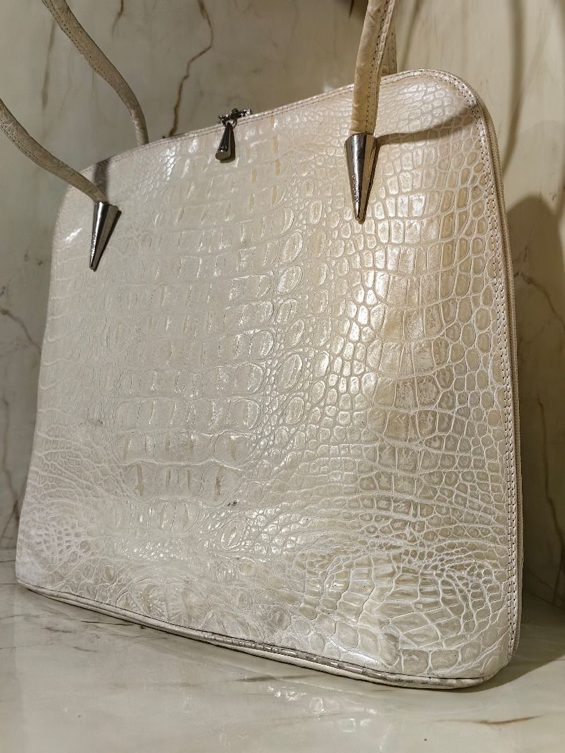 Cream Crocodile Leather Shoulder Bag (Category: Shoulder Bags) located in Tarlac. Submitted by jeremiah.curator.2026 (Listing ID 1468505569, Image 2). Description: - Color: Cream Crocodile Leather - Design: Structured shape with a flat bottom base - Straps: Dual shoulder straps featuring unique silver cone hardware accents - Closure: Secure top zip closure with cute tiny cone silver zipper pulls - Storage: Includes a convenient exterior back zipp