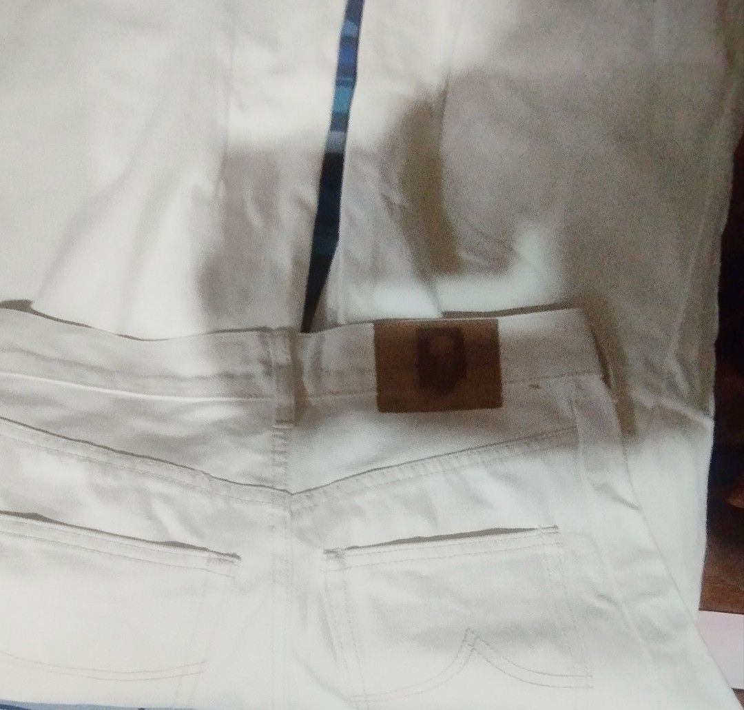Cream denim pants wideleg (Category: Jeans) located in Manila. Submitted by lene48 (Listing ID 1468551357, Image 2). Description: - Material: Classic white denim - Fit: Straight leg, mid-rise waist - Closure: Front button and zipper - Pockets: Front pockets, coin pocket, and two back pockets - Details: Brown leather patch on the waistband - Style: Versatile and neutral for daily casual outfits32 to 33waist .