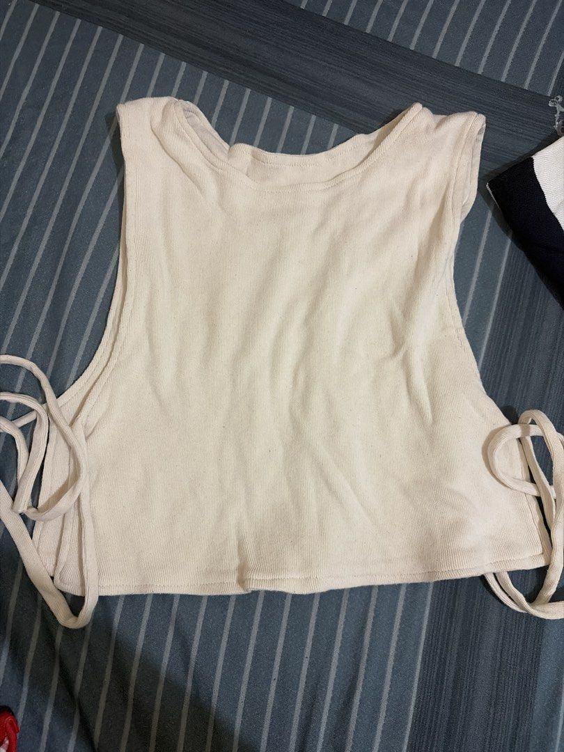 Cream Ribbed Tank Crop Top with Side Ties (Category: Sleeveless) located in Quezon City. Submitted by pika.lex (Listing ID 1468510159, Image 1). Description: - Color: Cream - Style: Ribbed tank crop top with relaxed fit - Material: Soft, comfortable knit - Features: Wide shoulder straps and adjustable side ties on both hems - Versatility: Perfect everyday basic, easy to pair with high-waisted jeans or skirts.