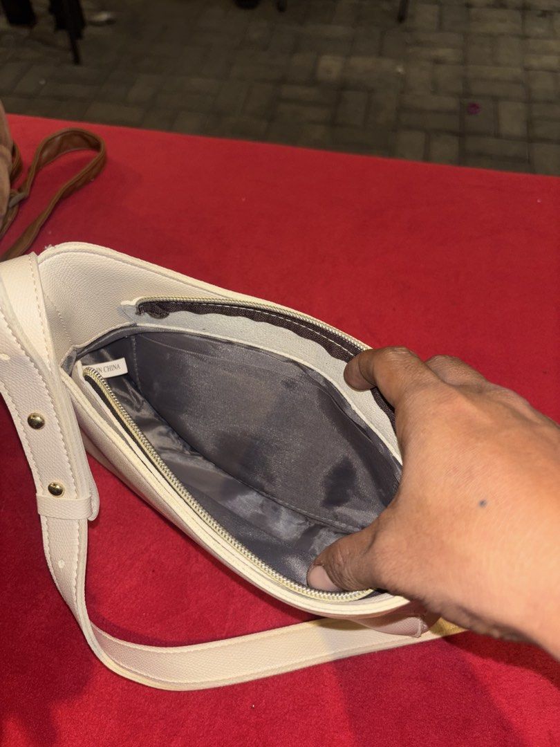 Cream White Shoulder Bag with Gold Hardware (Category: Shoulder Bags) located in Manila. Submitted by jeromskito66462 (Listing ID 1468668063, Image 3). Description: - Cream white faux leather shoulder bag - Adjustable strap with stylish gold metal studs - Secure zip top closure - Dark grey fabric lining with 'MADE IN CHINA' tag - Clean structure with a smooth finish - Perfect size for daily essentials like your phone, wallet, and keys.