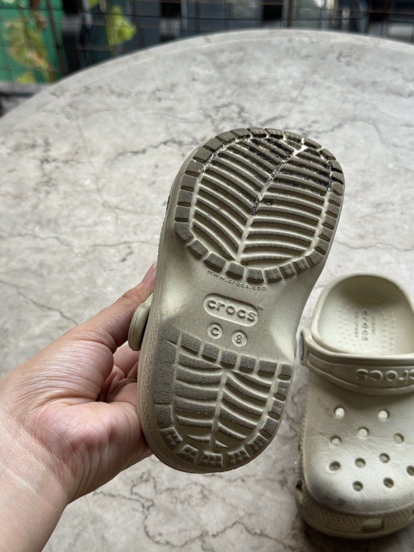 Crocs Classic Clog Bone Off-White Size C8 (Category: Babies & Kids Fashion) located in Quezon City. Submitted by pamyeloo (Listing ID 1468558148, Image 3). Description: - Color: Bone off-white - Size: C8 (stamped on bottom) - Style: Classic kids' slip-on clogs with secure heel strap - Features: Iconic comfort design with ventilation holes - Condition: Soles show dirt and wear from outdoor use.