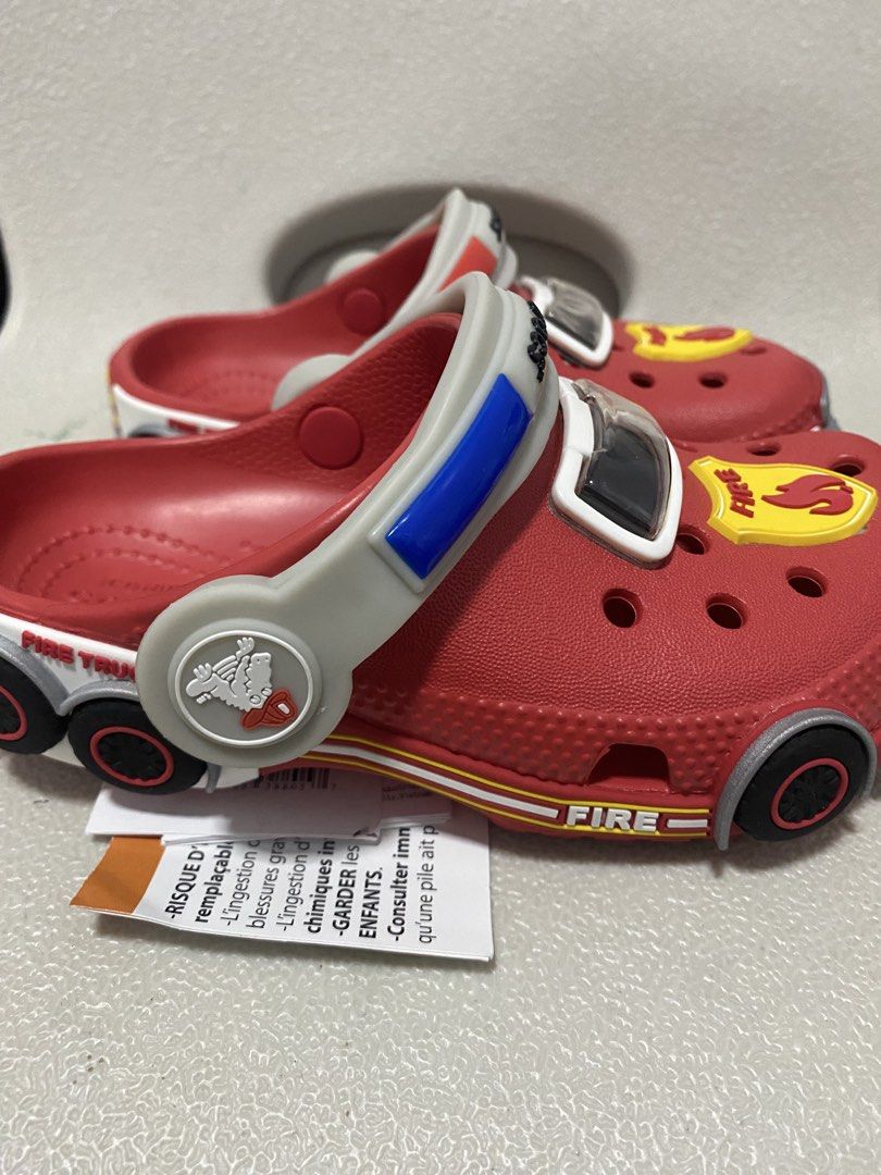 BRAND NEW Crocs Fire Truck Lights Clogs Kids Size C10 (Category: Babies & Kids Fashion) located in Santa Rita. Submitted by tine.s (Listing ID 1468525682, Image 3). Description: - Brand new with tags (never worn) - Size: US C10 / EUR 27-28 - Fun fire truck theme with bright red color, badges, and wheel prints - Features lights that activate when walking - Perfect gift for little fire truck fans.