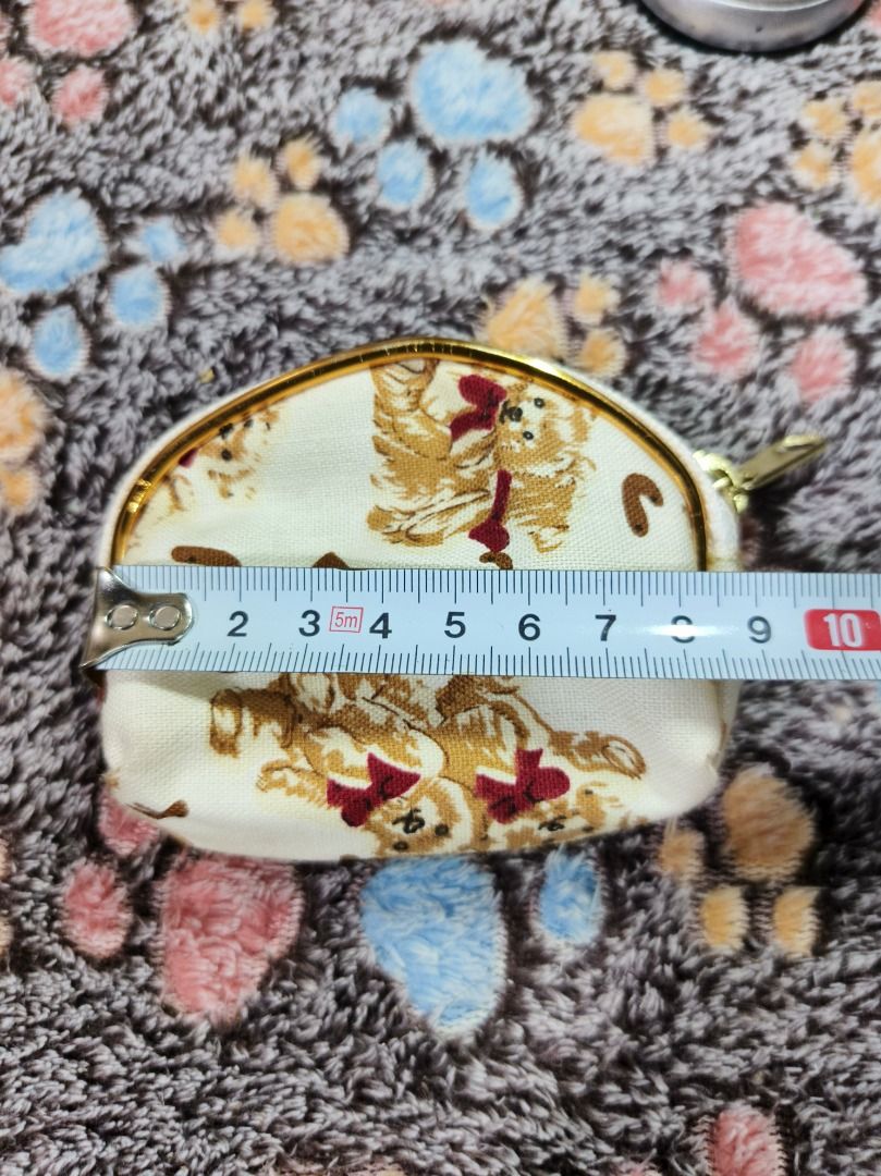 Cute bear pattern coin pouch zip wallet (Category: Purses & Pouches) located in San Leonardo. Submitted by burgossanleonardo.12345 (Listing ID 1468647065, Image 2). Description: - Color & Design: Cream-colored with adorable brown bear prints, red bows, and scattered alphabet letters - Hardware: Smooth gold-colored zipper frame - Interior: Fully lined with matching bear pattern fabric - Size: Handy and compact, perfect for coins, keys, or cards - 