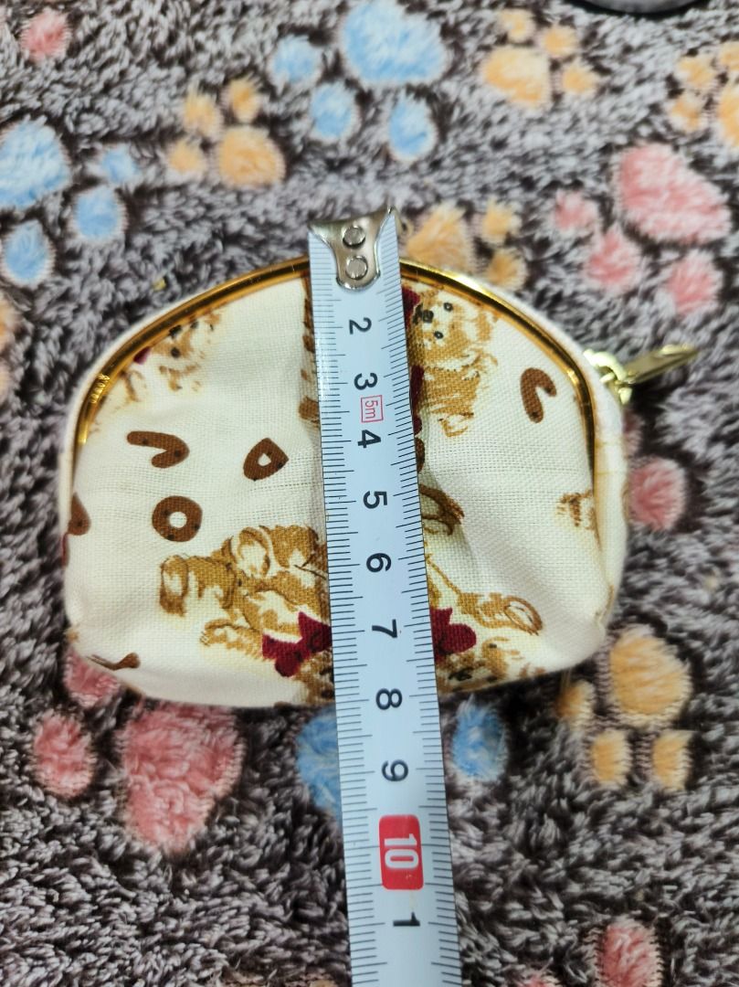 Cute bear pattern coin pouch zip wallet (Category: Purses & Pouches) located in San Leonardo. Submitted by burgossanleonardo.12345 (Listing ID 1468647065, Image 3). Description: - Color & Design: Cream-colored with adorable brown bear prints, red bows, and scattered alphabet letters - Hardware: Smooth gold-colored zipper frame - Interior: Fully lined with matching bear pattern fabric - Size: Handy and compact, perfect for coins, keys, or cards - 