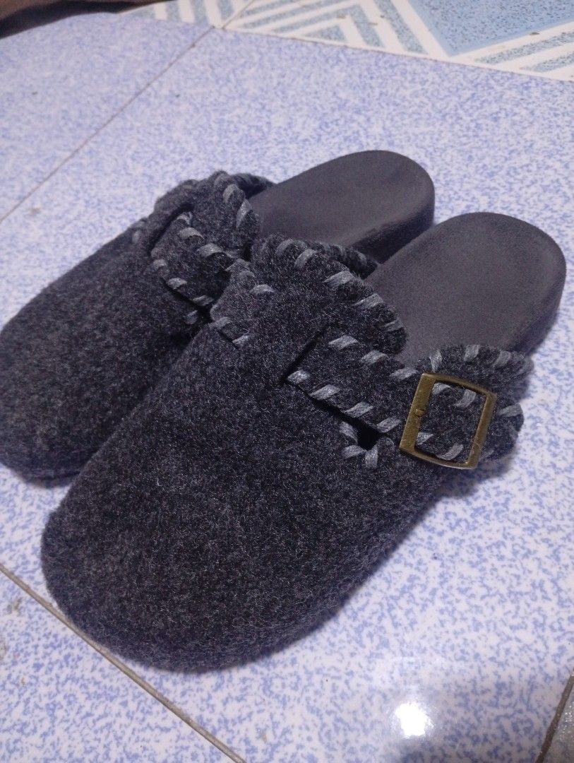 Dark Grey Felt Buckle Clogs Mule Slippers Size 39 (Category: Slippers and slides) located in Manila. Submitted by thehotness2.0 (Listing ID 1468598037, Image 3). Description: - Style: Birkenstock-style slip-on clogs - Color: Dark grey with contrast blanket stitching - Size: 39 - Material: Cozy wool-blend felt upper with textured black rubber outsole - Features: Decorative buckle strap for added style - Condition: Great for casual errands or home 