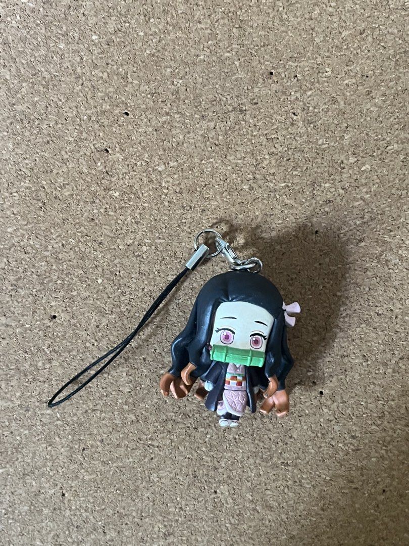 Demon Slayer Nezuko Anime Figure Strap Keychain (Category: Figurines & Statues) located in Baguio. Submitted by gaara1234 (Listing ID 1468526428, Image 1). Description: - Character: Nezuko (Demon Slayer) - Design: Chibi figurine with signature pink eyes, bamboo muzzle, and orange-tipped hair - Attachment: Black phone strap loop with a secure metal clasp - Condition: Minor paint wear on hands and hair ends - Uses: Great cute accessory for phones, 