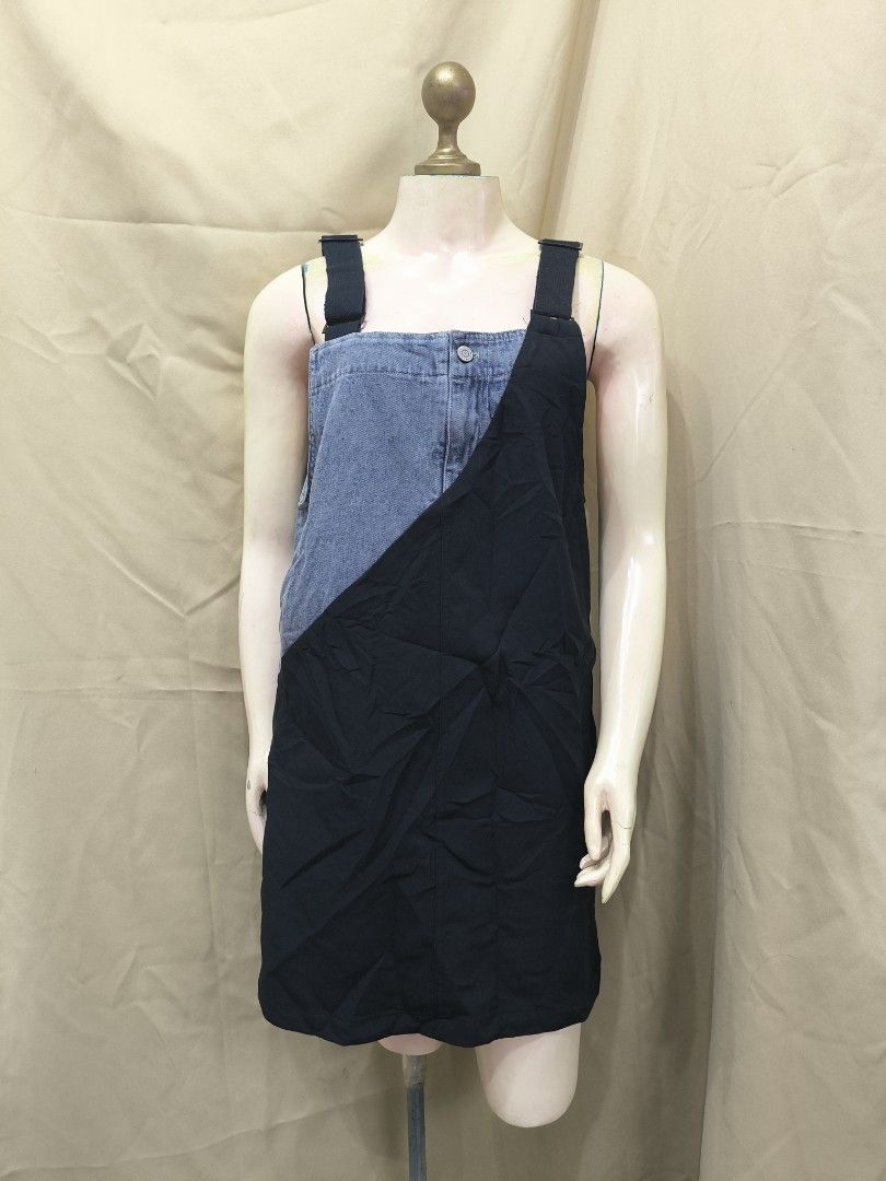 Denim Black Patchwork Overall Dress Pinafore (Category: Dresses) located in Marikina City. Submitted by mrlfashion23 (Listing ID 1468589363, Image 1). Description: - Style: Patchwork mini overall dress with a trendy diagonal split design - Material: Combination of classic blue denim and solid black fabric - Features: Thick black straps, single front button closure near the neckline, and a straight hem ending above the knees - Versatility: Easy sl