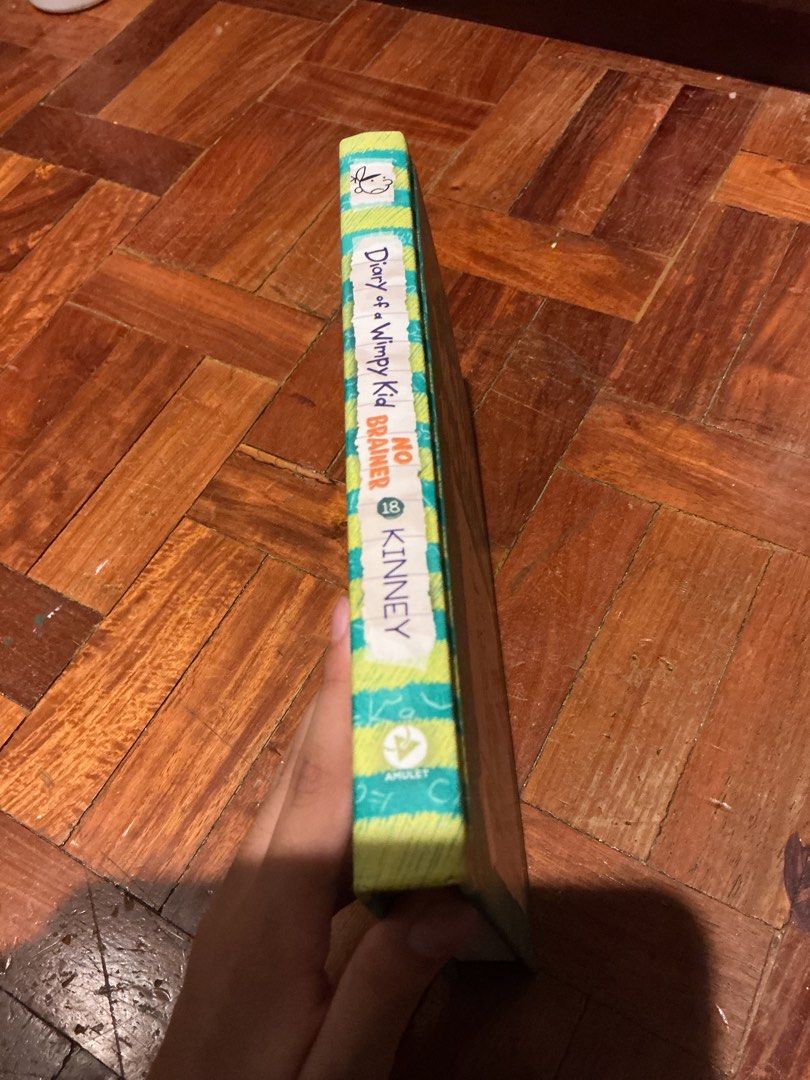 Diary of a Wimpy Kid No Brainer (Category: Children's Books) located in Muntinlupa City. Submitted by antonrizz (Listing ID 1468606832, Image 3). Description: - Title: Diary of a Wimpy Kid #18: No Brainer - Author: Jeff Kinney - Format: Hardcover (Amulet Books edition) - Design: Green cover with math formulas pattern - Condition: Read once, like new - Pages: Crisp and clean - Spine: Intact with no folds or creases.