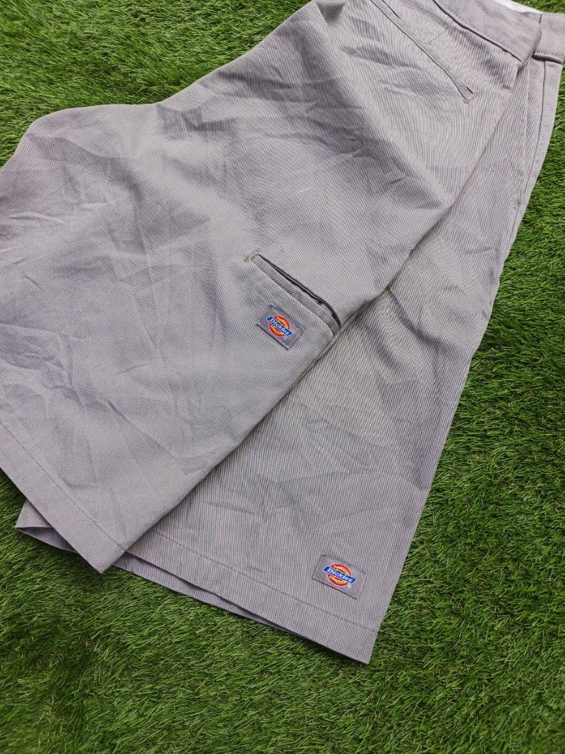 Dickies grey work shorts (Category: Shorts) located in Dipolog. Submitted by vinzz_thrift (Listing ID 1468600657, Image 3). Description: - Brand: Dickies - Color: Grey - Style: Flat front shorts with zip fly and sturdy belt loops - Details: Classic logo patches on the pocket and hem - Condition: Clean inside waistband lining, great for daily wear.