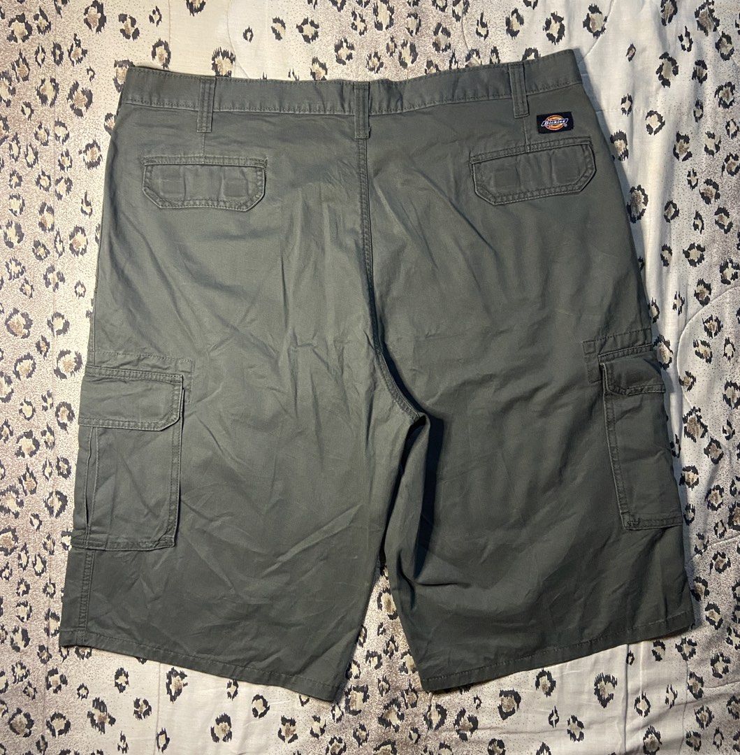Dickies Olive Green Cargo Shorts (Category: Shorts) located in Manila. Submitted by nix.thrift (Listing ID 1468608614, Image 2). Description: - Brand: Dickies - Color: Dark Olive Green - Fit: Relaxed fit through the legs - Material: Durable cotton fabric for everyday wear - Storage: Multiple side and back pockets - Details: Button closure, zip fly, sturdy belt loops, and classic logo patch - Condition: Great for casual or workwear styling.