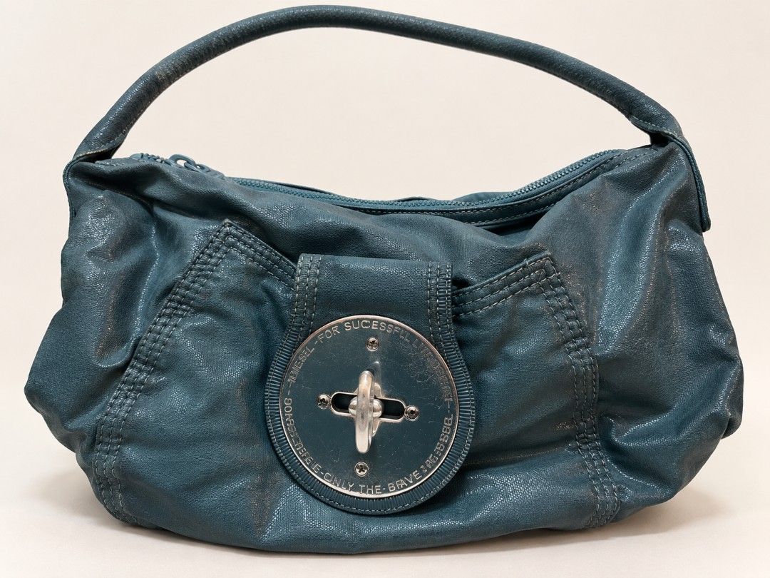 Diesel Y2k hobo bag (Category: Shoulder Bags) located in Manila. Submitted by littleclosetfindsmnl (Listing ID 1468543871, Image 1). Description: Vintage Y2K Diesel Hobo Shoulder Bag 🩵 Teal/turquoise vintage Diesel bag with signature circular turn-lock detail. Shows signs of wear and minimal scratches on hardware which is normal. Open to reasonable offers! ✨ RFS:Decluttering.