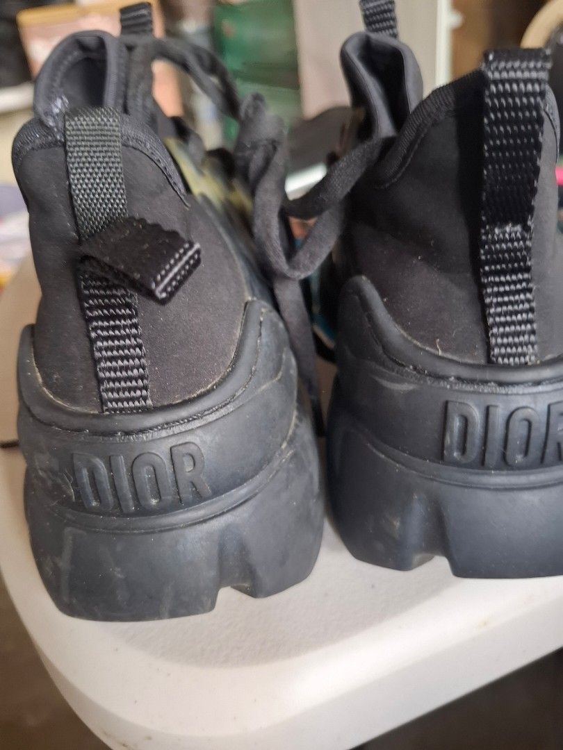 Dior Black High-Top Sneakers Size 35 (Category: Sneakers & Footwear) located in Marikina City. Submitted by bags21.ph (Listing ID 1468504129, Image 2). Description: - Authentic Black Dior high-top sneakers - Size: 35 (Made in Italy stamp on sole) - Unique lace-up design with clear rubber eyelet tabs - Trendy chunky rubber soles - Heel pull tab with embossed Dior branding on back - Condition: Regular wear on treads, overall well-maintained - Messa