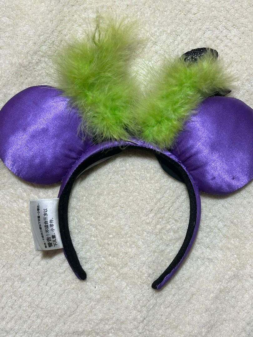 Disney Maleficent Spell Headband (Category: Hair Accessories) located in Las Pinas. Submitted by whatzupriley (Listing ID 1468555397, Image 2). Description: - Authentic Disney Parks Spell Bound collection Maleficent headband - Purple satin ears with striking black thorn print - Black patent bow featuring a large crystal centerpiece - Detailed with small black horns and green feather accents - Comfortable purple headband with original Disney Parks
