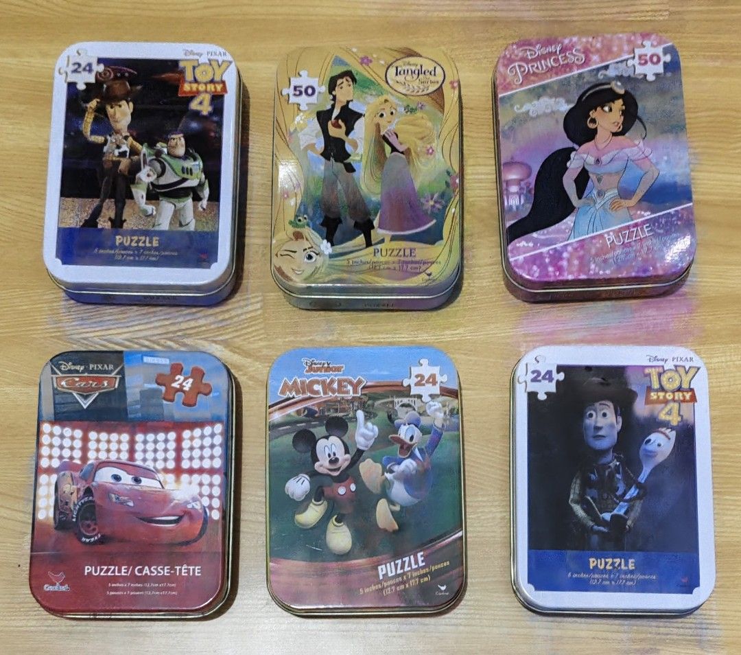Disney Pixar Puzzle Tin Assortment 6-Pack (Category: Board Games & Puzzles) located in San Pedro. Submitted by toydibz (Listing ID 1468553818, Image 1). Description: - Set of 6 collectible Disney and Pixar character tins - Features Toy Story, Tangled, Disney Princess, Cars, and Mickey Mouse - Each tin includes a small, fun jigsaw puzzle for kids - Tins double as safe storage for puzzle pieces - Great activity for kids and collectors alike.