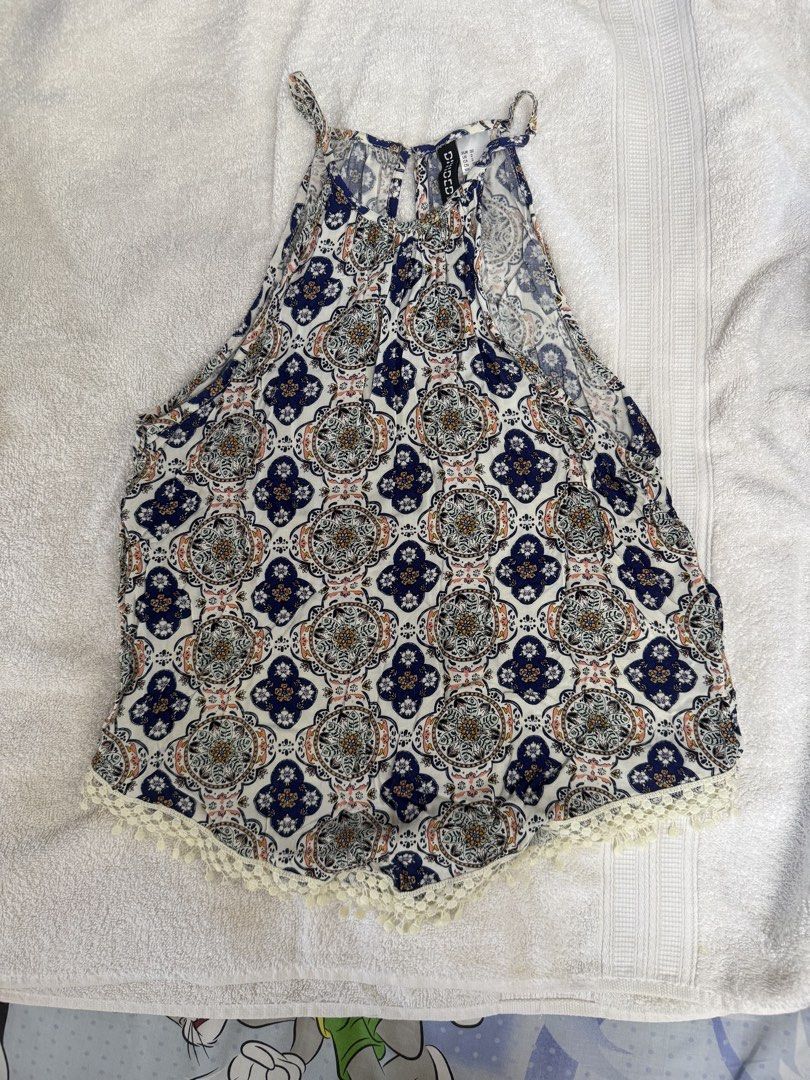 Divid H&M Halter Neck Tapestry Pattern Tank Top Size US 2 (Category: Sleeveless) located in Paranaque City. Submitted by LMWaf (Listing ID 1468552413, Image 1). Description: - Brand: Divided by H&M - Size: US 2 / EUR 32 - Design: Blue, white, and multicolored tapestry/medallion print - Details: Halter neck, keyhole button closure at back, delicate crochet lace trim on curved hem - Material: Lightweight and breathable fabric.
