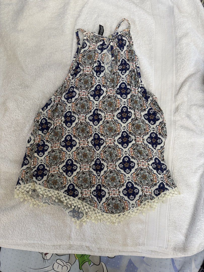 Divid H&M Halter Neck Tapestry Pattern Tank Top Size US 2 (Category: Sleeveless) located in Paranaque City. Submitted by LMWaf (Listing ID 1468552413, Image 2). Description: - Brand: Divided by H&M - Size: US 2 / EUR 32 - Design: Blue, white, and multicolored tapestry/medallion print - Details: Halter neck, keyhole button closure at back, delicate crochet lace trim on curved hem - Material: Lightweight and breathable fabric.