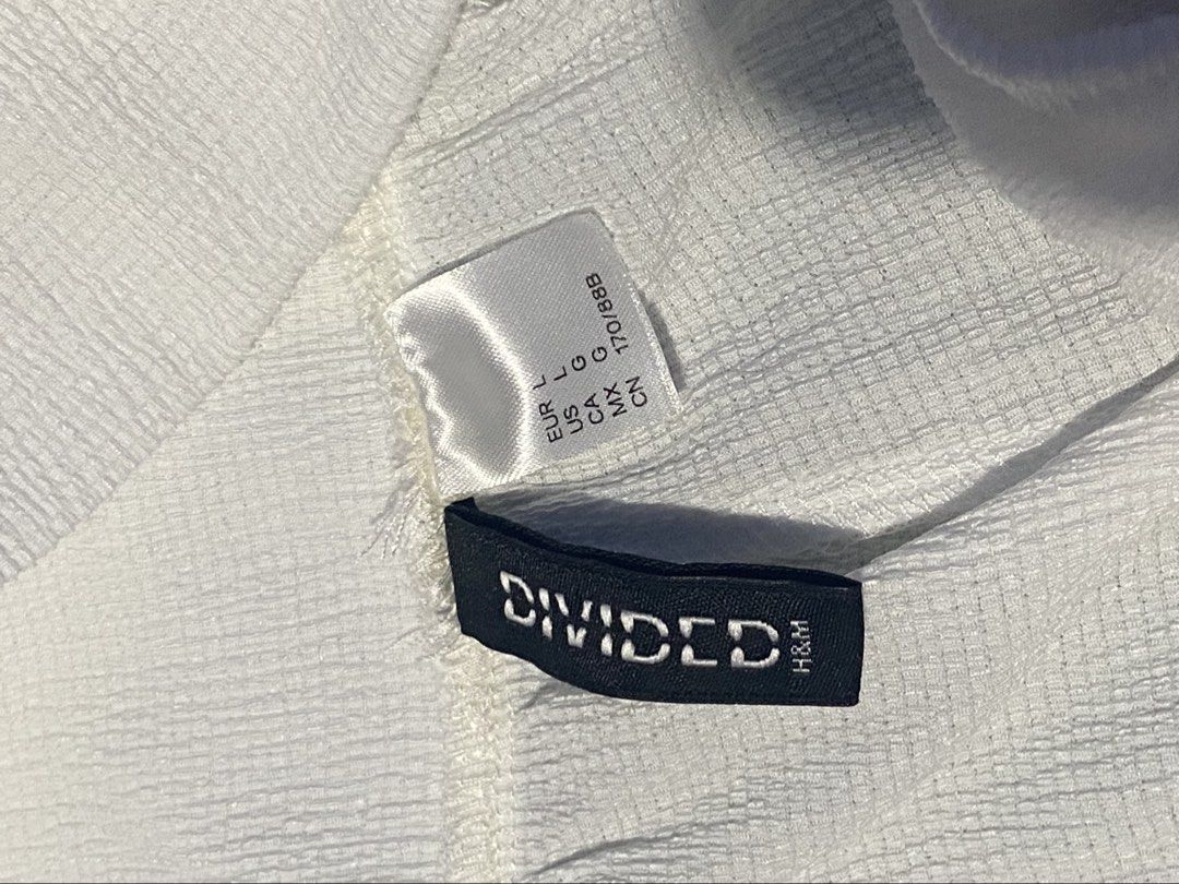 Divided by H&M White Textured Cuffed Harem Pants Size L (Category: Jeans) located in Manila. Submitted by jolinyaaa (Listing ID 1468683390, Image 2). Description: - Brand: H&M (Divided) - Size: L (Tag attached) - Color: Solid white - Material: Lightweight textured crinkle fabric - Fit: Relaxed slouchy fit through the legs - Details: Elastic waistband and gathered elastic ankle cuffs - Styling: Easy to match with crop tops or basic tees Never used
