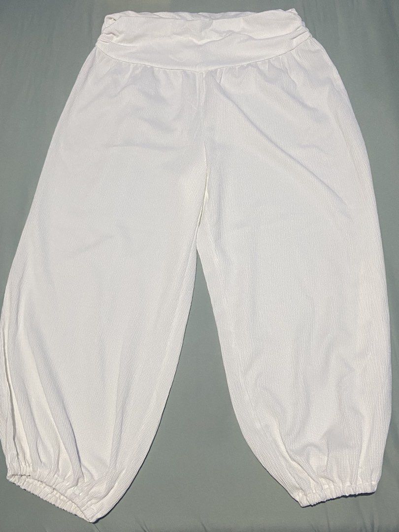Divided by H&M White Textured Cuffed Harem Pants Size L (Category: Jeans) located in Manila. Submitted by jolinyaaa (Listing ID 1468683390, Image 1). Description: - Brand: H&M (Divided) - Size: L (Tag attached) - Color: Solid white - Material: Lightweight textured crinkle fabric - Fit: Relaxed slouchy fit through the legs - Details: Elastic waistband and gathered elastic ankle cuffs - Styling: Easy to match with crop tops or basic tees Never used