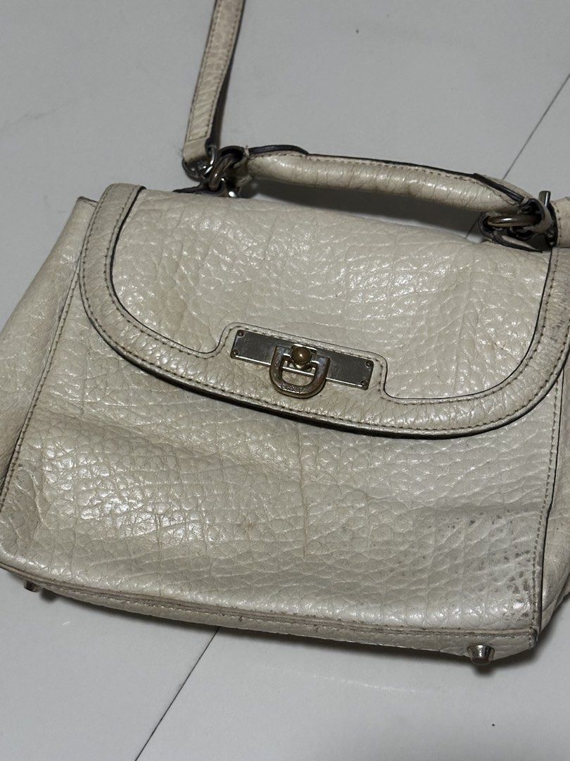 DKNY White Sling/Hand Bag (Category: Cross-body Bags) located in Manila. Submitted by velaiyara (Listing ID 1468644189, Image 2). Description: swipe to see flaws removable sling.