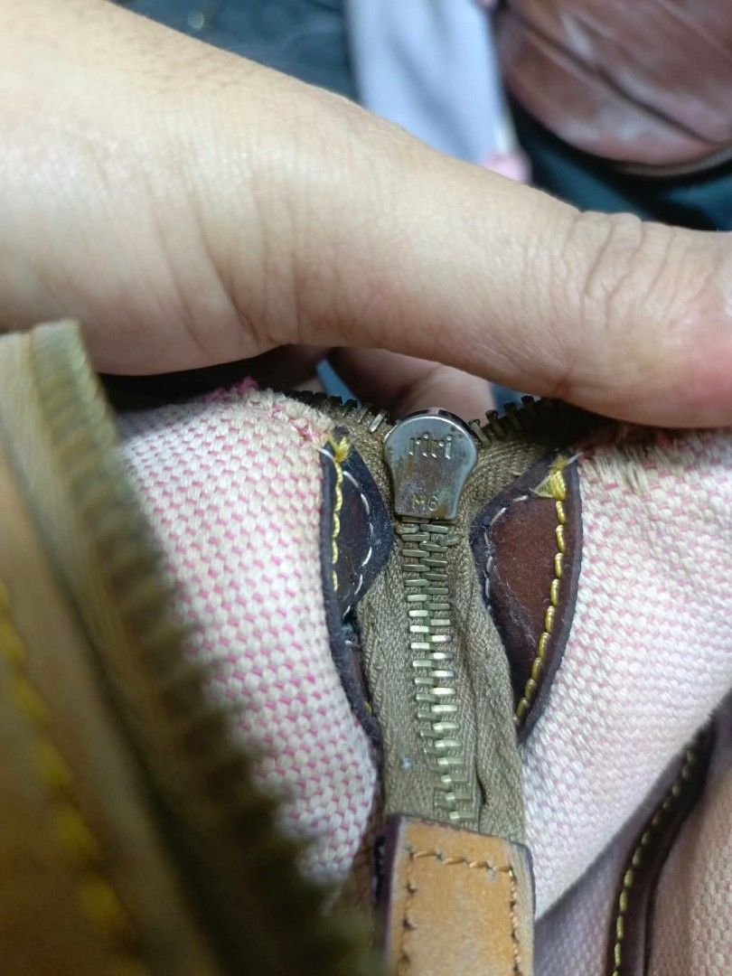 Dooney & Bourke Tan Leather Shoulder Bag (Category: Luxury Bags & Wallets) located in Manila. Submitted by dei03_diz (Listing ID 1468543956, Image 3). Description: - Brand: Dooney & Bourke - Material: Tan pebbled leather with brown leather trim - Hardware: Iconic metal duck logo plaque on front, Riri zipper closure - Interior: Pink checkered fabric lining with a zipper pocket and brand tag - Condition: Shows natural wear on the leather and slight