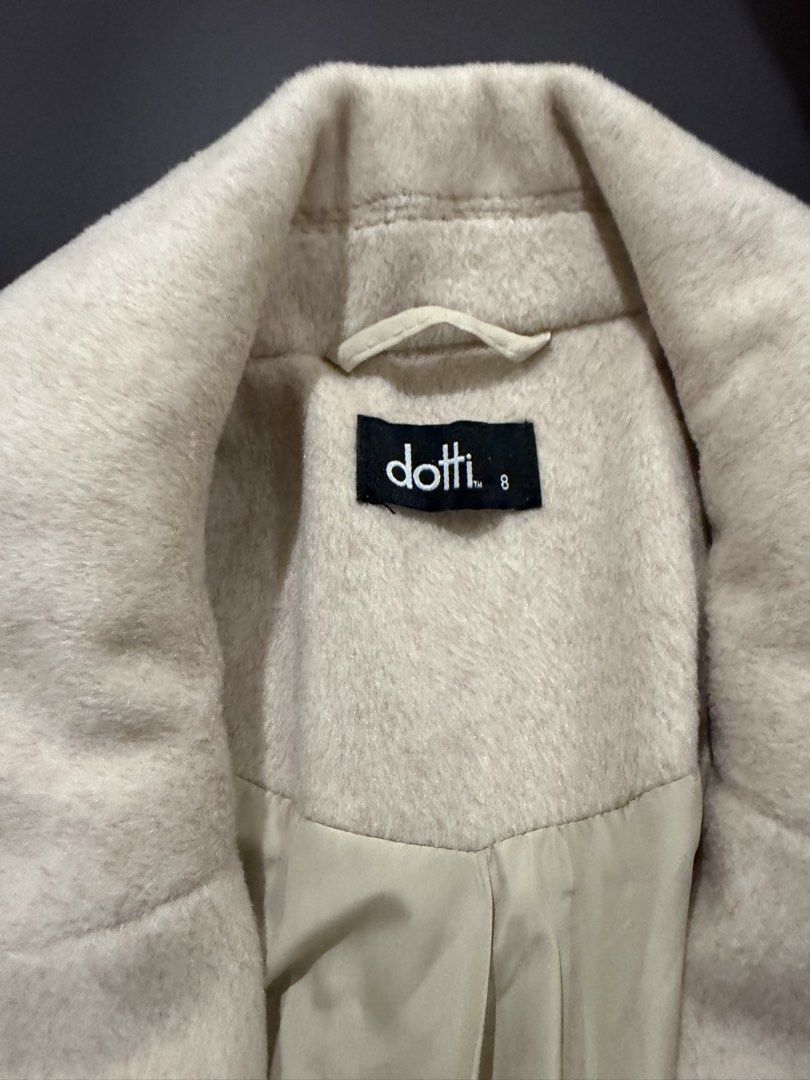 Dotti Beige Wool Coat Size 8 (Category: Coats, Jackets and Outerwear) located in Quezon City. Submitted by kimioutlet (Listing ID 1468607206, Image 3). Description: - Brand/Model: Dotti Beige Wool Coat - Size: 8 - Design: Classic longline cut with structured lapels - Closure: Two brown buttons down the front - Pockets: Deep pockets on both sides - Interior: Fully lined for extra warmth - Style: Neutral cream shade, perfect for easy layering in co