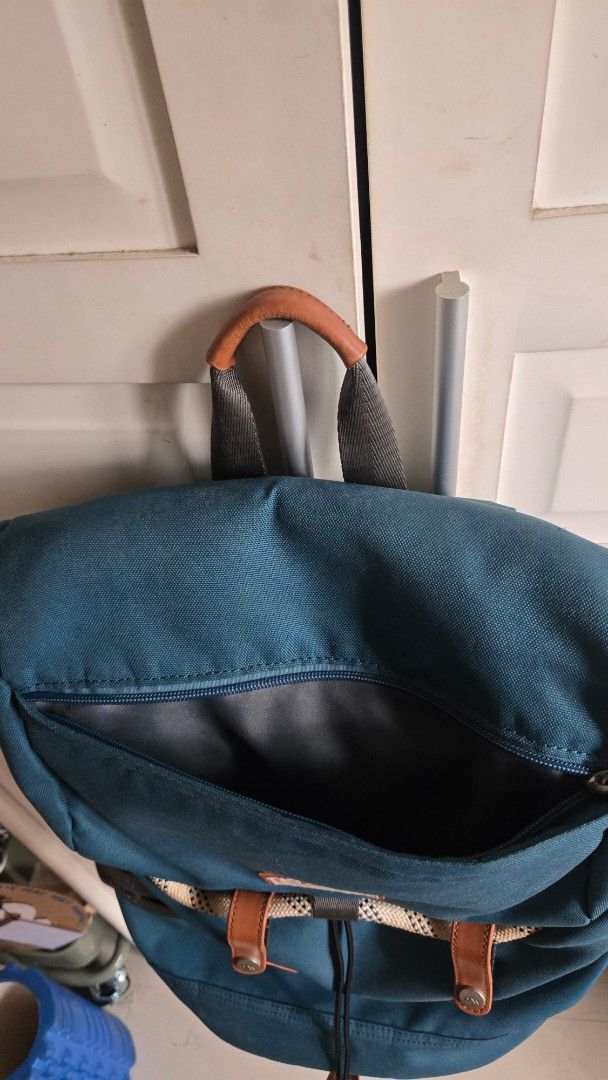 Doughnut Blue Canvas Backpack with Brown Leather Accents (Category: Backpacks) located in Mandaluyong City. Submitted by ohayouclub (Listing ID 1468529268, Image 3). Description: - Brand/Model: Doughnut Backpack in Dark Teal Blue - Material & Accents: Durable canvas with brown leather and rope details - Closure: Drawstring main closure with secure buckle straps - Comfort & Carry: Padded shoulder straps equipped with metal D-rings - Storage: Conve