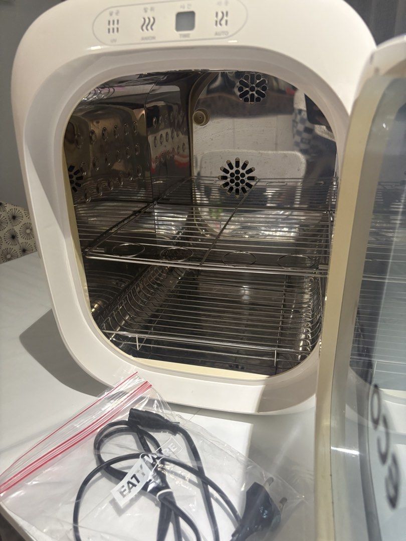 Ecomom Eco 100 Dual UV Sterilizer (Category: Breastfeeding & Bottle Feeding) located in Manila. Submitted by naturemomph2020 (Listing ID 1468573265, Image 2). Description: - Brand: Ecomom Eco 100 Dual UV Sterilizer - Color: Silver and White - Condition: Excellent / Well-maintained - Made in Korea & FDA registered medical device - Multi-purpose: Sterilizer, dryer, and deodorizer (99.9% bacteria elimination) - Safe for baby bottles, toys, and gadge