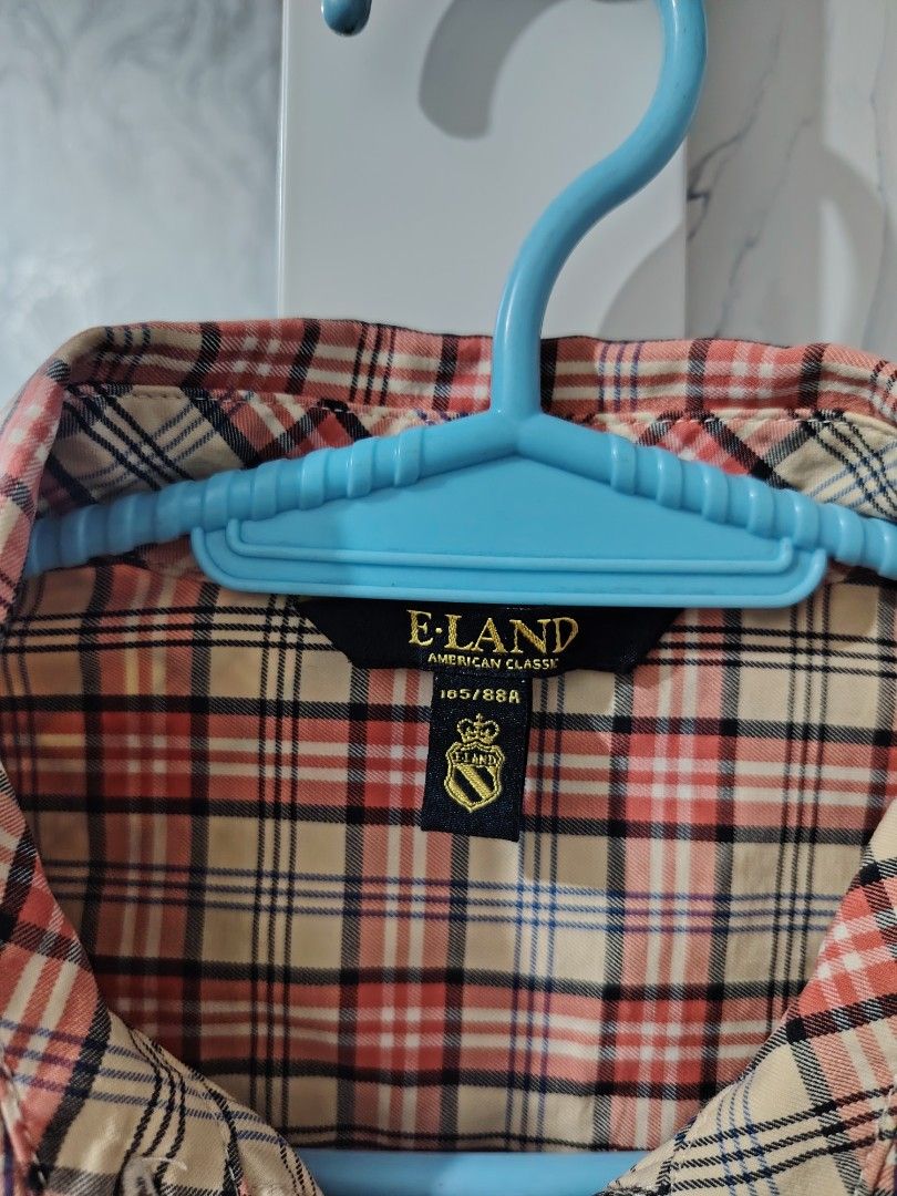 E-LAND Plaid Long Sleeve Button-Down Blouse (Category: Longsleeves) located in Valenzuela. Submitted by zealstar.48eb73 (Listing ID 1468668662, Image 2). Description: - Brand: E-LAND - Pattern: Classic plaid (red, cream, and dark blue tones) - Features: Long sleeves, pointed collar, sweet ruffle trim placket, and embroidered chest logo - Size: 165/88A - Condition: Excellent pre-loved condition - Perfect for: Preppy, casual, or office-chic outfits