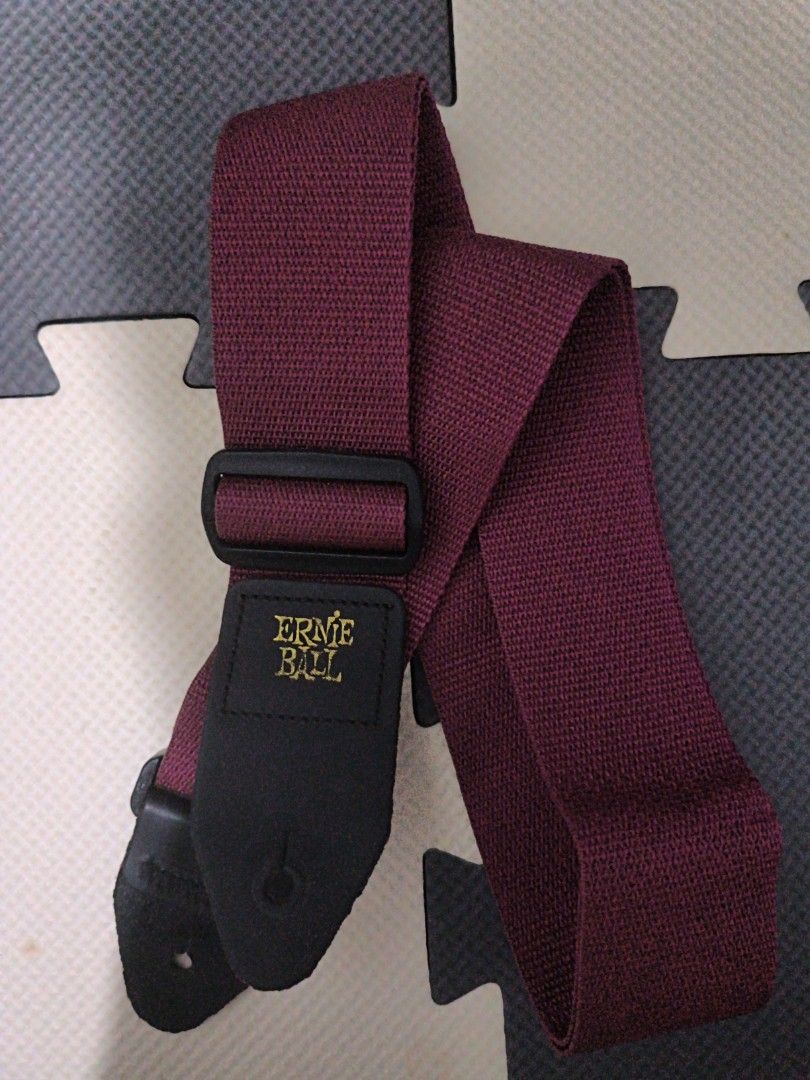 Ernie Ball Polypro Guitar Strap Burgundy (Category: Music Accessories) located in Manila. Submitted by eediso10 (Listing ID 1468581959, Image 1). Description: - Brand: Ernie Ball - Color: Burgundy with gold stamped logo - Material: Durable woven polypropylene with black leather ends - Hardware: Adjustable plastic buckle - Compatibility: Suitable for acoustic, electric, and bass guitars - Condition: Brand new / Excellent quality.