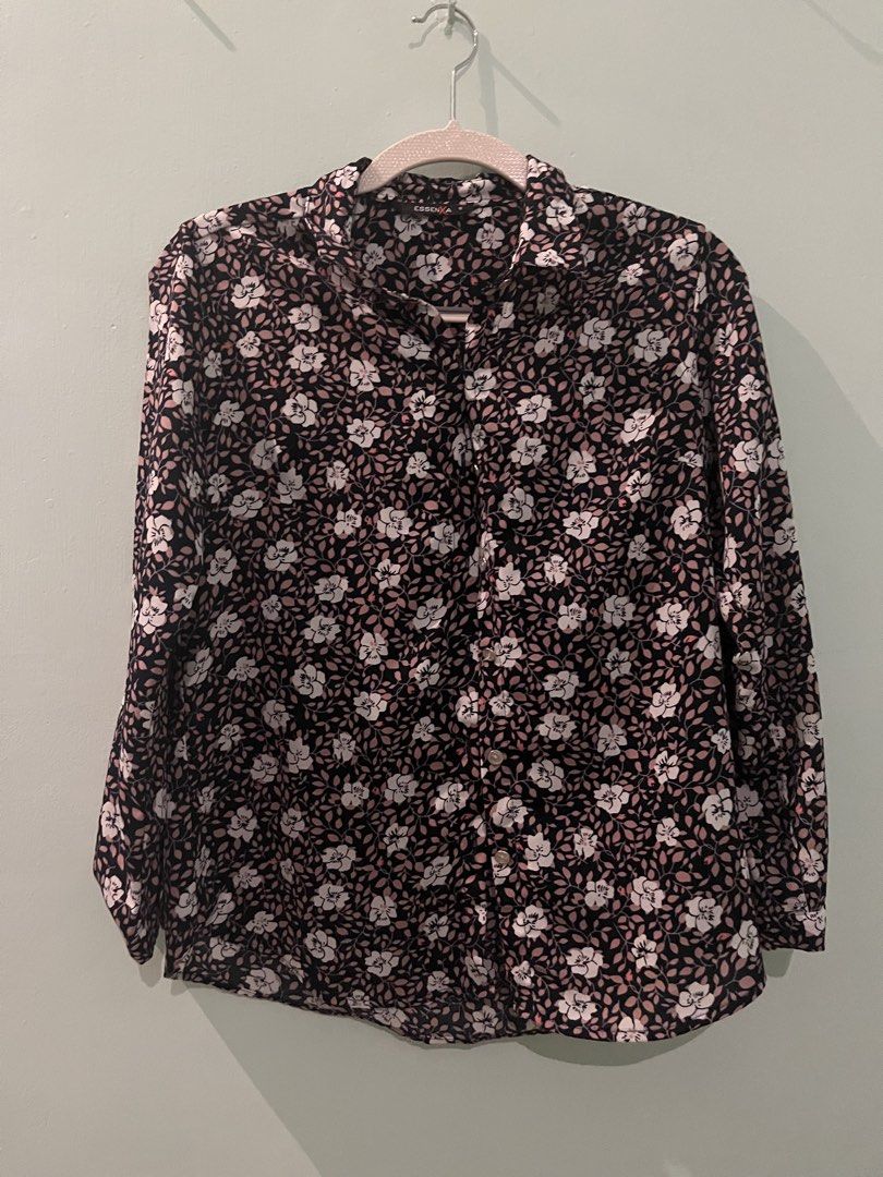 EssenXer Floral Long Sleeve Button Down Blouse Size S (Category: Longsleeves) located in Pasig City. Submitted by fmc828 (Listing ID 1468508364, Image 1). Description: - Brand: EssenXer - Style: Button-down shirt with pointed collar and curved hem - Design: Black base with a vibrant white and pink floral pattern - Fit & Size: Women's Small, lightweight fabric - Versatility: Perfect for both office wear and casual weekend outings - Condition: Grea