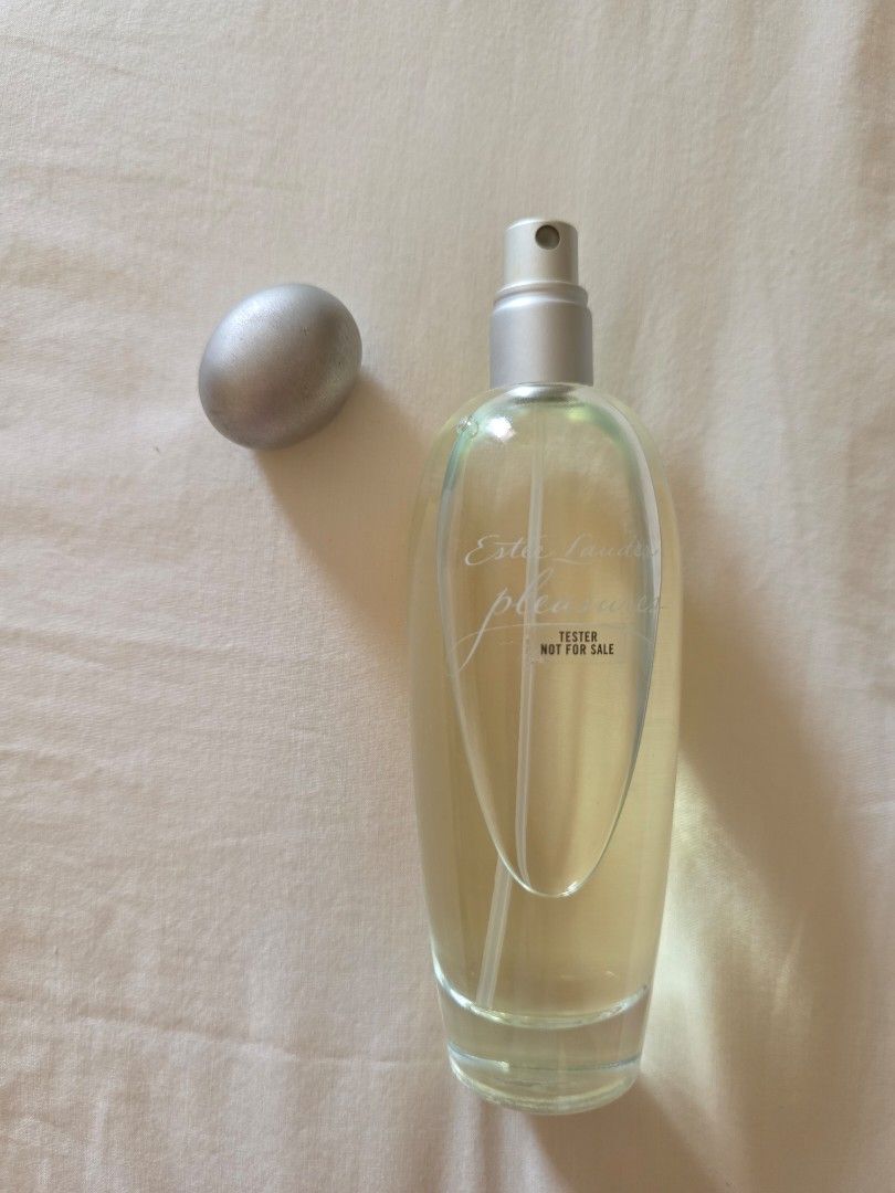 Estee Lauder Pleasures Eau de Parfum Spray 100ml Tester (Category: Fragrance & Deodorants) located in Pasig City. Submitted by kwishhy (Listing ID 1468532030, Image 3). Description: - Brand: Estee Lauder Pleasures Eau de Parfum - Size: 100ml - Type: Tester unit - Design: Clear glass cylindrical body with embossed text and silvery cap/pump - Batch Code: A59 (bottom sticker with production details) - 100% authentic and fresh.