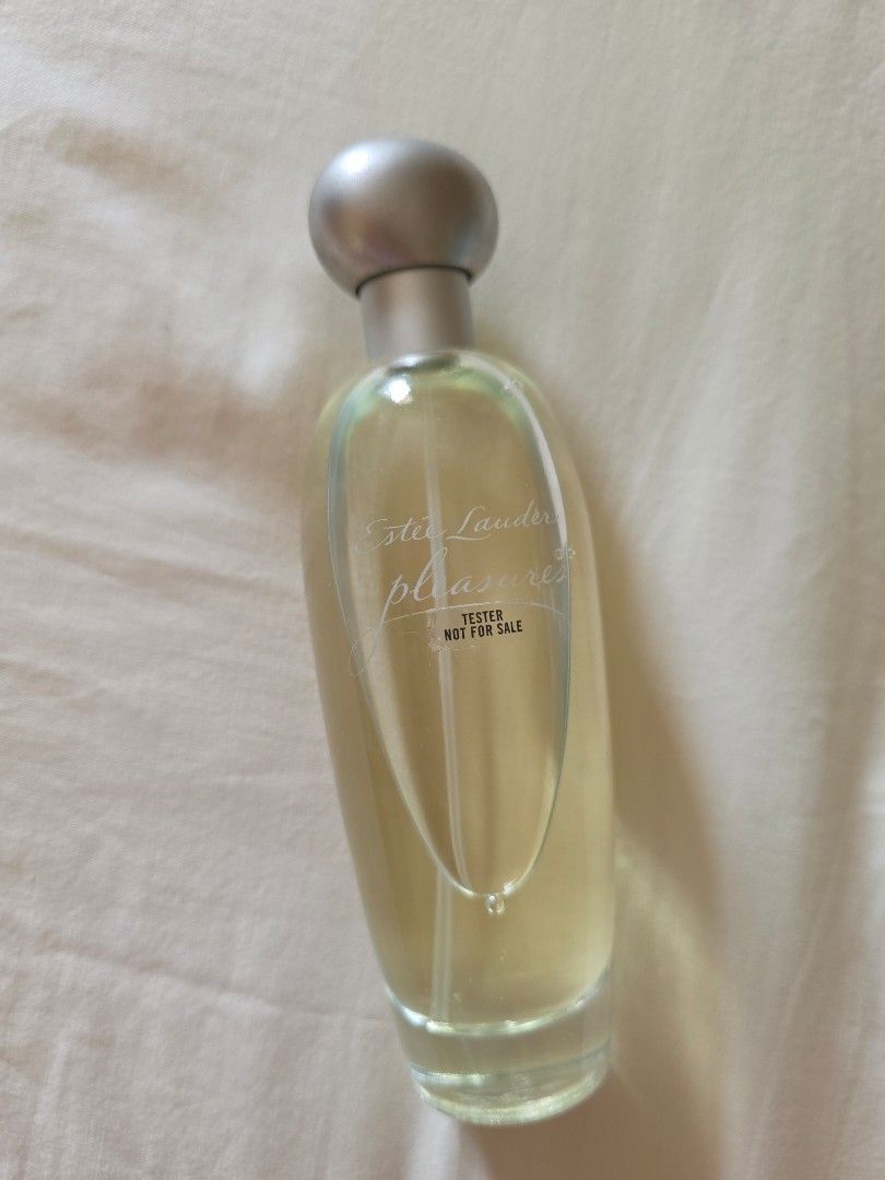 Estee Lauder Pleasures Eau de Parfum Spray 100ml Tester (Category: Fragrance & Deodorants) located in Pasig City. Submitted by kwishhy (Listing ID 1468532030, Image 2). Description: - Brand: Estee Lauder Pleasures Eau de Parfum - Size: 100ml - Type: Tester unit - Design: Clear glass cylindrical body with embossed text and silvery cap/pump - Batch Code: A59 (bottom sticker with production details) - 100% authentic and fresh.