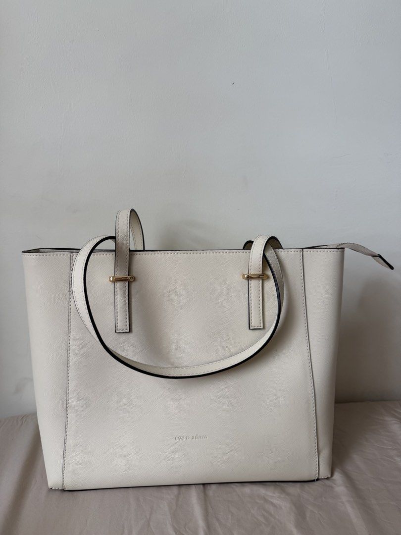Eve & Adam White Tote Bag (Category: Tote Bags) located in Manila. Submitted by dropd3ad (Listing ID 1468512242, Image 1). Description: - Brand: Eve & Adam - Color: Classic White - Material: Structured saffiano finish - Hardware: Elegant gold-toned accents - Closure: Zip top for security - Interior: Spacious and clean - Perfect for: Work, school, or daily casual outings - Condition: Excellent / Brand new (ready to ship!) - Never been used 📍Pampa
