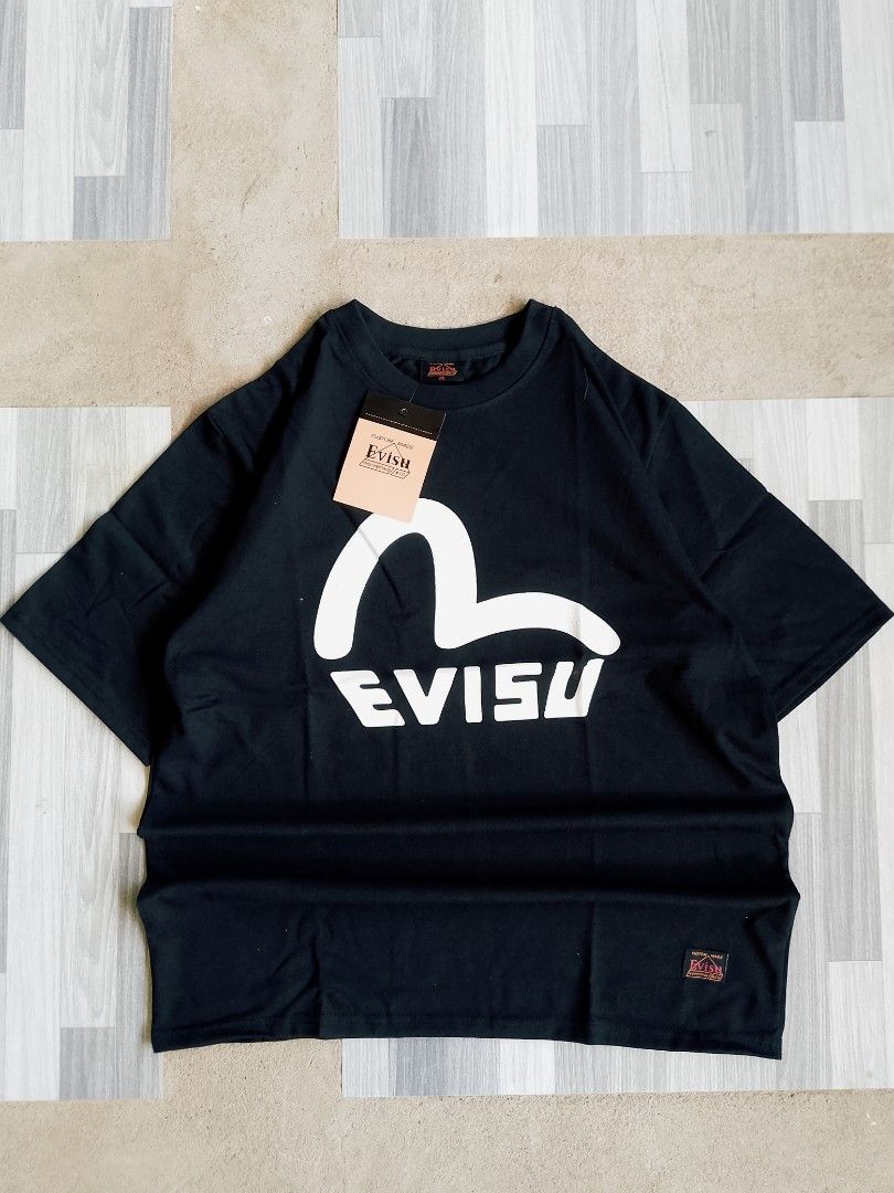 Evisu Black T-Shirt with Seagull Logo (Category: Tshirts & Polo Shirts ) located in Batangas. Submitted by rafstaywitstaff_11 (Listing ID 1468532432, Image 1). Description: - Brand: Evisu - Color: Black - Size: XL - Condition: Brand new with original hangtag attached - Design: Large white seagull graphic on the chest with a subtle wave pattern - Details: Features Evisu Heritage & Co branding tag sewn near the bottom hem and inside the collar - 10