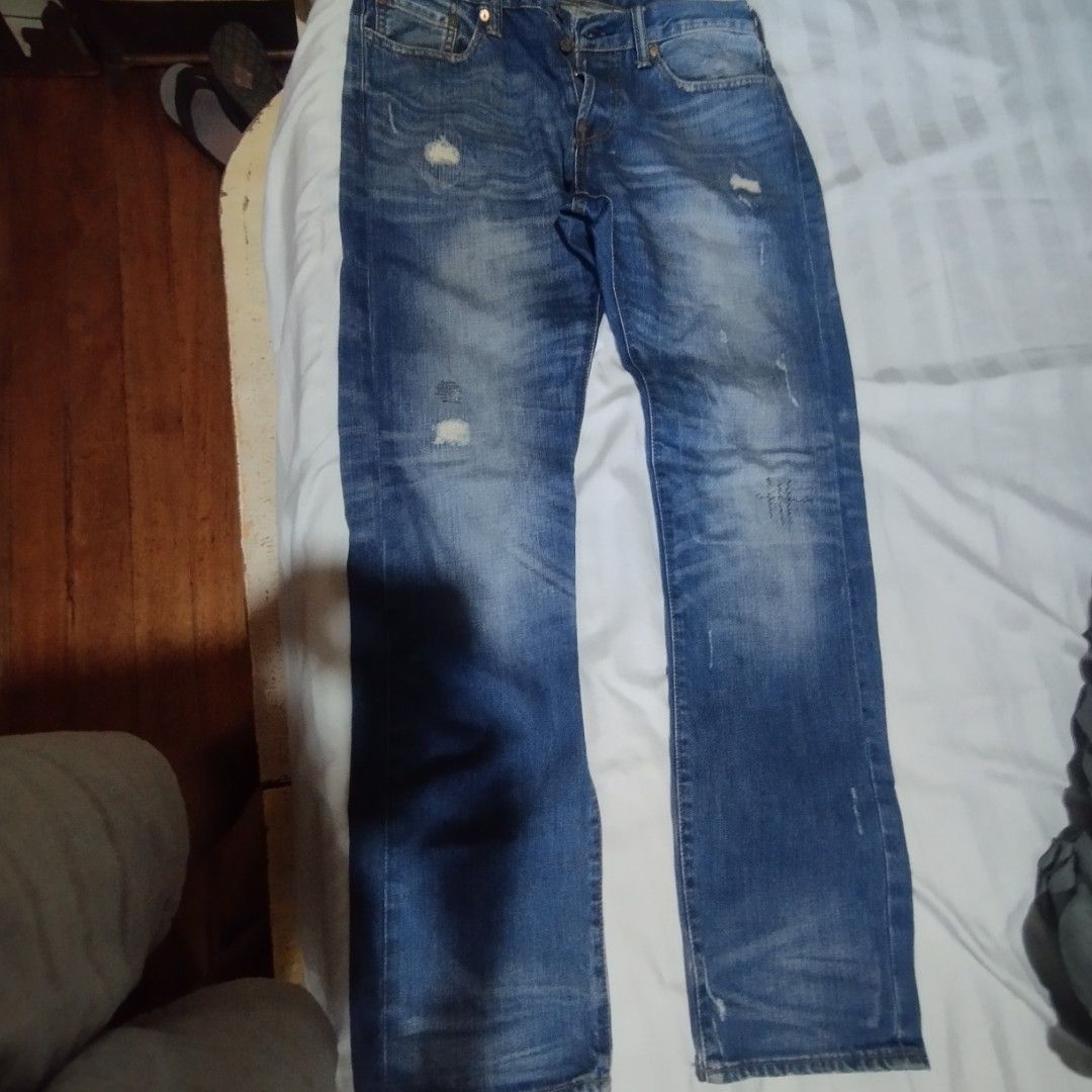 Evisu Blue Distressed Denim Jeans (Category: Jeans) located in Manila. Submitted by lene48 (Listing ID 1468648545, Image 2). Description: - Mid wash blue distressed denim jeans - Button fly closure - Unique blue painted graphics on back pockets and interior waistband - Genuine leather back patch - Branded pocket lining - Stylish whiskering and distressing throughout.