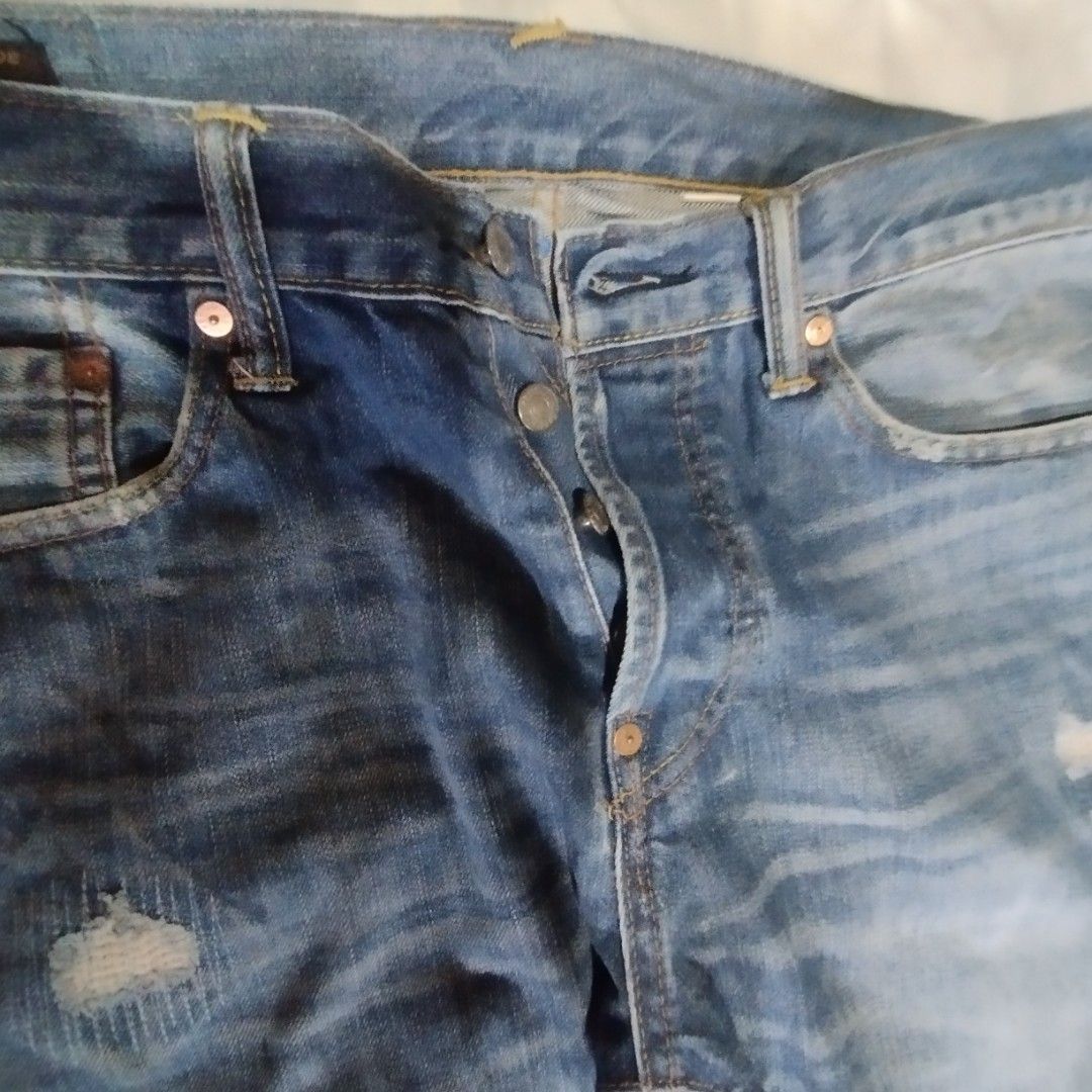 Evisu Blue Distressed Denim Jeans (Category: Jeans) located in Manila. Submitted by lene48 (Listing ID 1468648545, Image 3). Description: - Mid wash blue distressed denim jeans - Button fly closure - Unique blue painted graphics on back pockets and interior waistband - Genuine leather back patch - Branded pocket lining - Stylish whiskering and distressing throughout.
