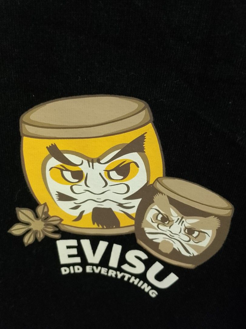 Evisu Heritage & Co Daruma T-Shirt (Category: Tshirts & Polo Shirts ) located in Quezon City. Submitted by viaggo.travels (Listing ID 1468547256, Image 3). Description: - Brand: Evisu Heritage & Co - Color: Black - Size: S to M - Design: Daruma graphic and 'Evisu Did Everything' text on chest - Material: Heavy cotton fabric for a comfortable fit - Details: Woven collar tape, custom neck tag, and God of Wealth stamp care label - Style: Premium str