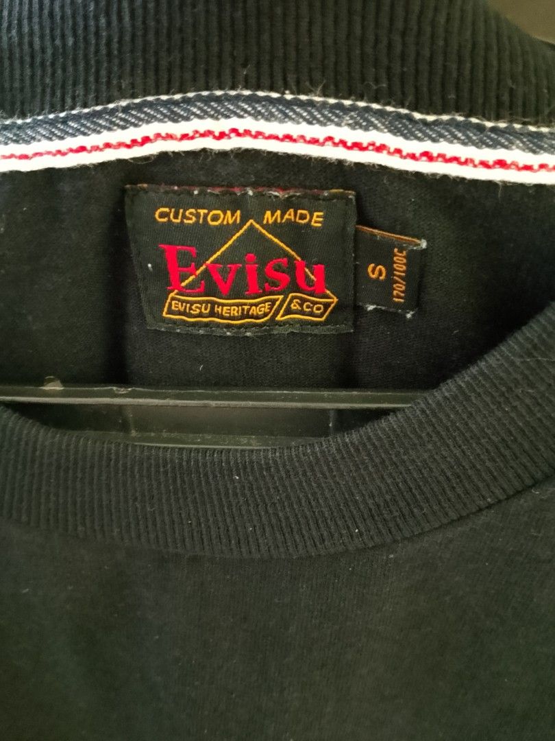 Evisu Heritage & Co Daruma T-Shirt (Category: Tshirts & Polo Shirts ) located in Quezon City. Submitted by viaggo.travels (Listing ID 1468547256, Image 1). Description: - Brand: Evisu Heritage & Co - Color: Black - Size: S to M - Design: Daruma graphic and 'Evisu Did Everything' text on chest - Material: Heavy cotton fabric for a comfortable fit - Details: Woven collar tape, custom neck tag, and God of Wealth stamp care label - Style: Premium str