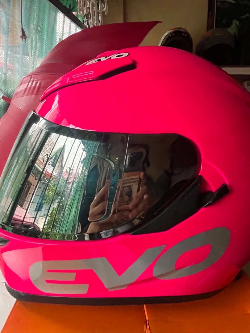 Evo Pink Motorcycle Helmet With Extra Visor (Category: Bicycles) located in Cavite. Submitted by kawaiijhen16 (Listing ID 1468709791, Image 2). Description: - Brand: Evo - Color: Bright pink with bold grey logo - Visors included: Dark tinted (installed) and extra clear anti-scratch (in packaging) - Features: Clean interior lining, adjustable chin strap, quick-release buckle - Inclusion: Matching black Evo storage bag - Condition: Ready for use.