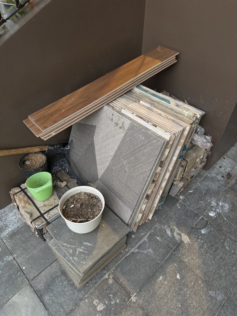 Excess Assorted ceramic floor tiles and bundles (Category: Carpets, Mats & Flooring) located in Cavite. Submitted by CLKSC (Listing ID 1468592530, Image 3). Description: - Bundle includes: Stack of grey patterned ceramic tiles, a few loose pieces, and several wood-look planks - Condition: Dusty from storage, but solid and usable - Best for: Small DIY projects, floor patching, or crafting tabletops - Sale terms: Take everything together (no tingi)