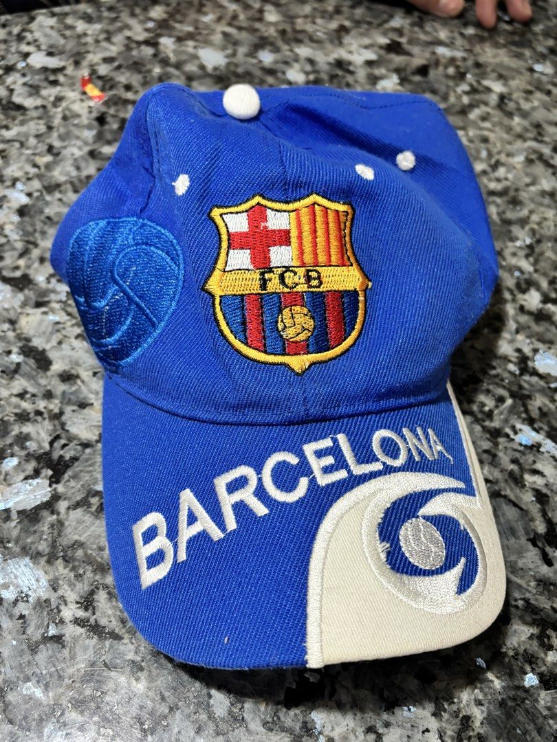 FC Barcelona Blue Baseball Cap Hat (Category: Caps & Hats) located in Taytay. Submitted by chippylala (Listing ID 1468641763, Image 1). Description: - Authentic FC Barcelona design in a bright blue colorway - Features embroidered club crest on the front - Stylish white 'BARCELONA' lettering on the brim - Contrasting white and beige side panels - Adjustable strap closure at the back for a custom fit - Perfect for match days and everyday wear for f
