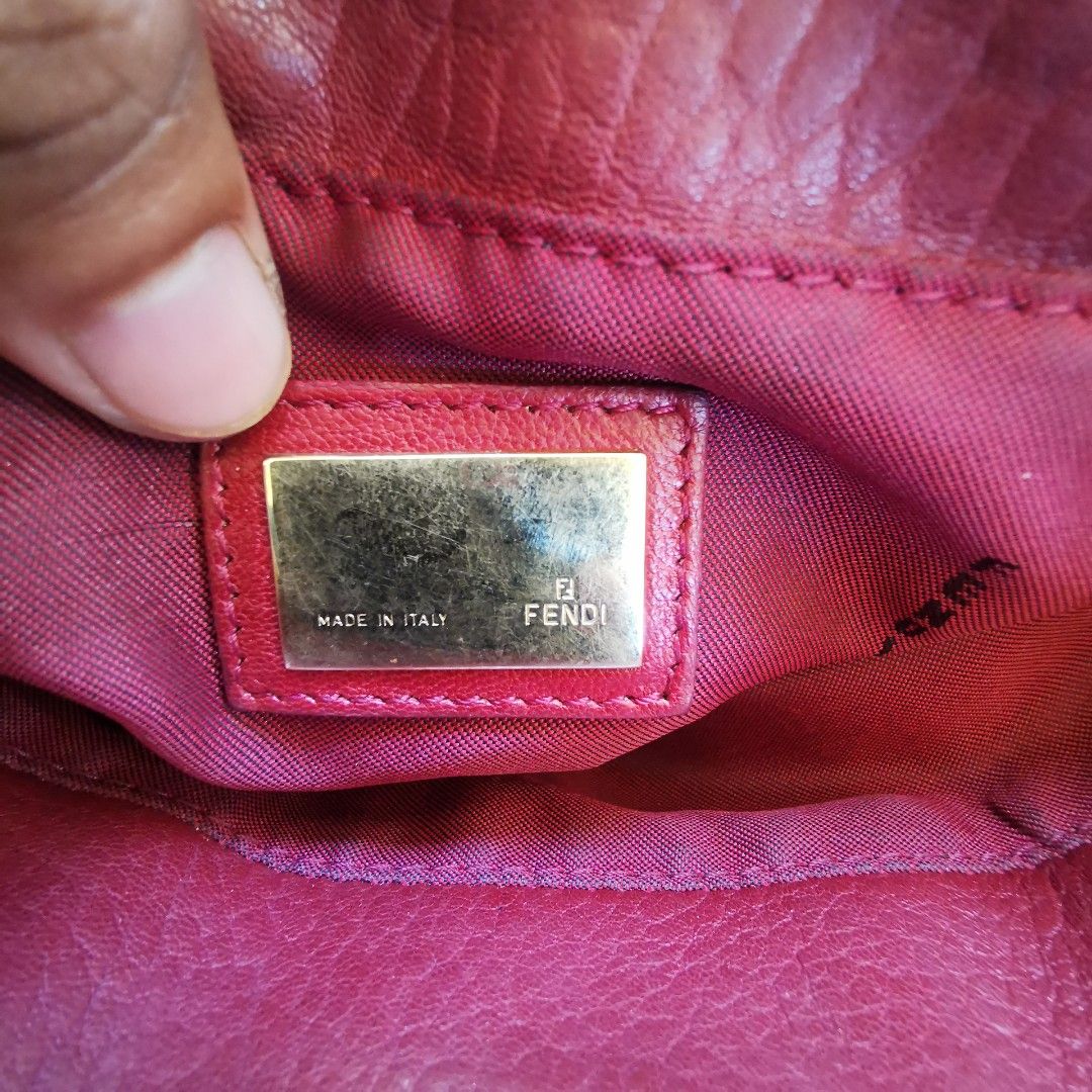 Fendi Red Leather Tote Bag (Category: Tote Bags) located in Davao. Submitted by dmp1993 (Listing ID 1468581445, Image 3). Description: Deep red leather tote bag from Fendi. Gold-tone hardware with the Fendi logo plate on the front. Double top handles. Interior lined in fabric with zipper pocket, Fendi metal plaque, and authenticity tag. Made in Italy. Zipper pull engraved with Fendi branding..