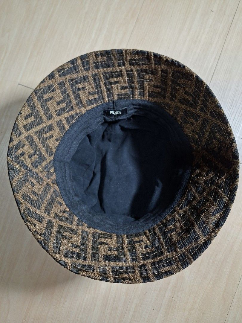 Fendi Zucca FF Logo Brown Bucket Hat (Category: Caps & Hats) located in Baguio. Submitted by restyrille77846 (Listing ID 1468643639, Image 3). Description: - Brand: Fendi - Design: Classic brown and black FF Zucca logo print - Interior: Dark lining with stitched Fendi Roma tag - Features: Structured brim, lightweight fabric - Style: Ultimate streetwear accessory.